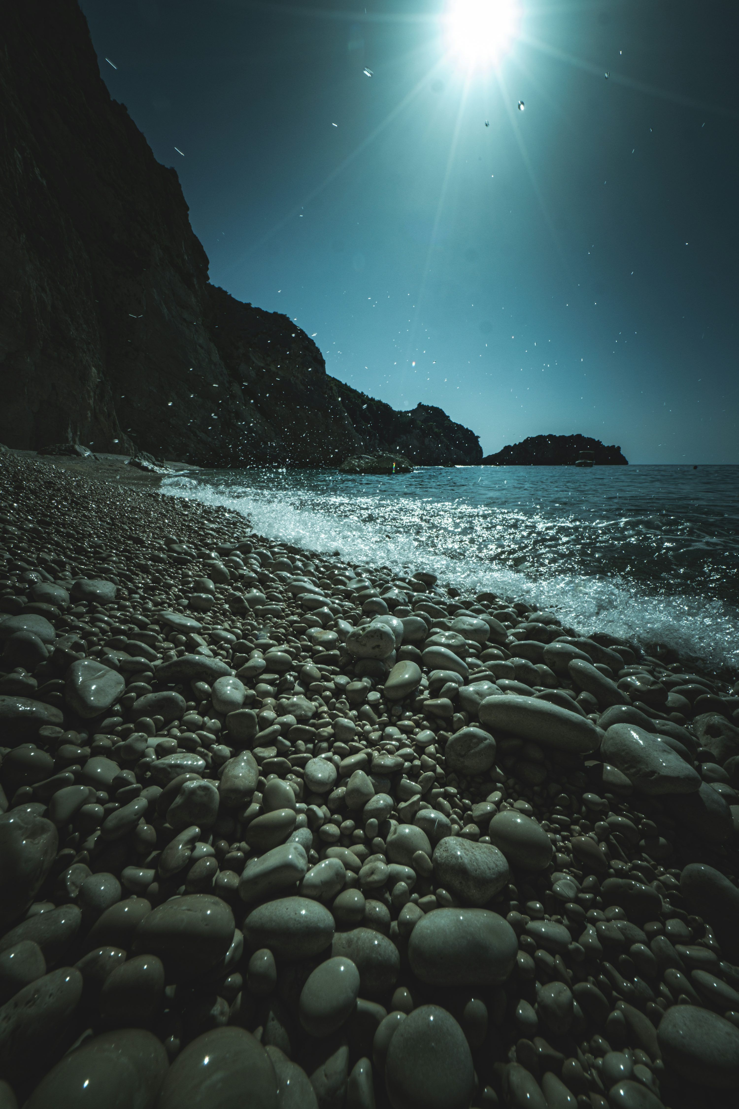 3000x4500 A full moon shines over a rocky beach photo