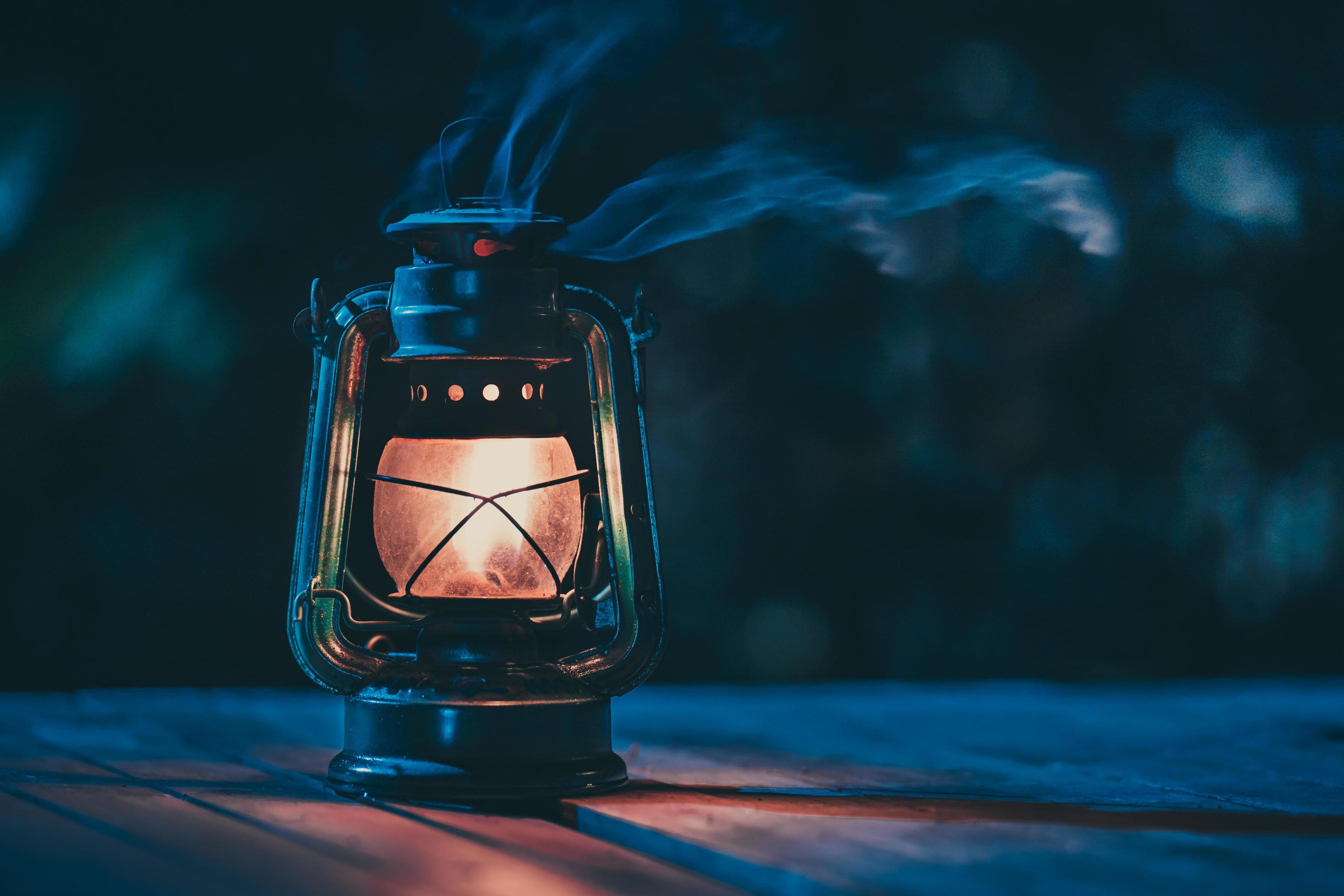 2940x1960 antique kerosene lamp with lights on the wooden floor on the lawn at night