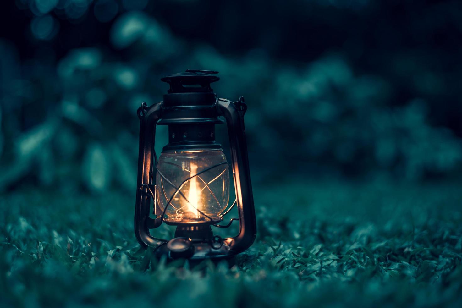 1470x980 antique kerosene lamp on the grass in the forest at night.soft focus
