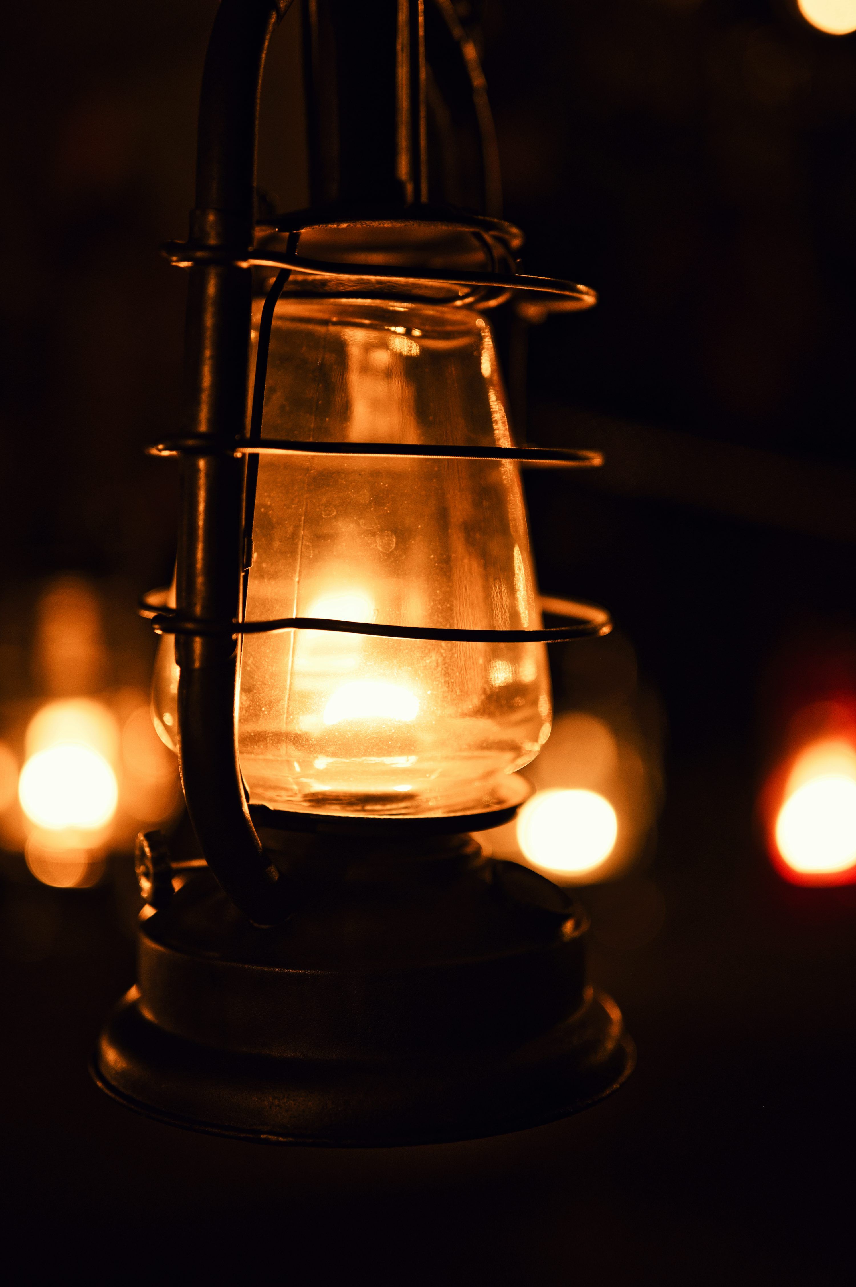 3000x4509 A vintage lantern glows warmly in the darkness. photo