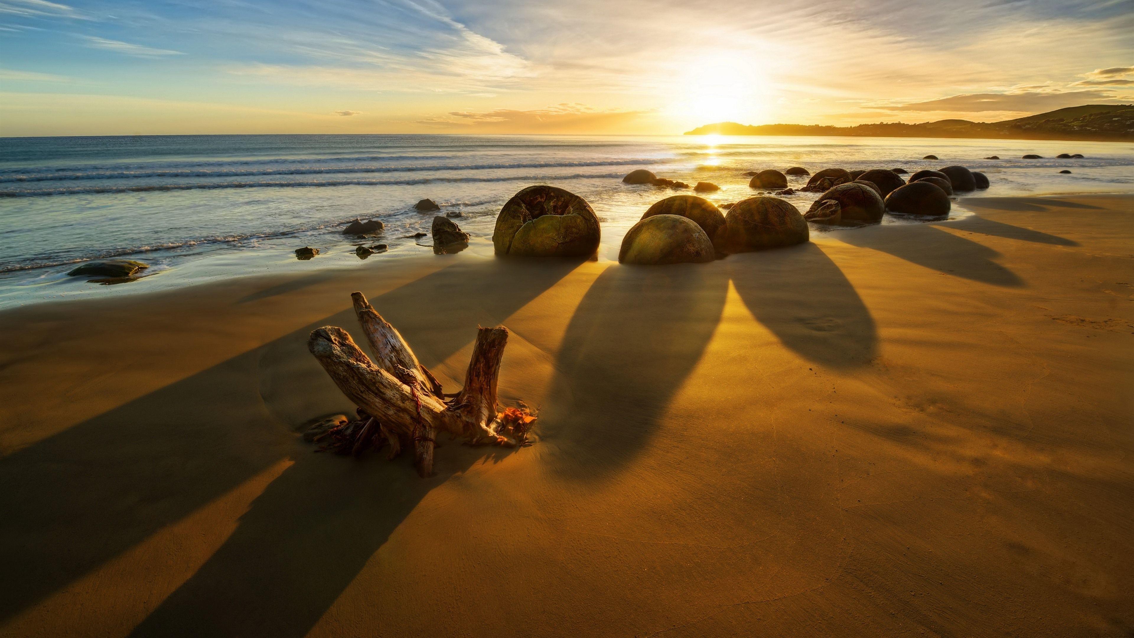 3840x2160 Wallpaper New Zealand, sea, stones, sunset, rocks, beach 3840x2160