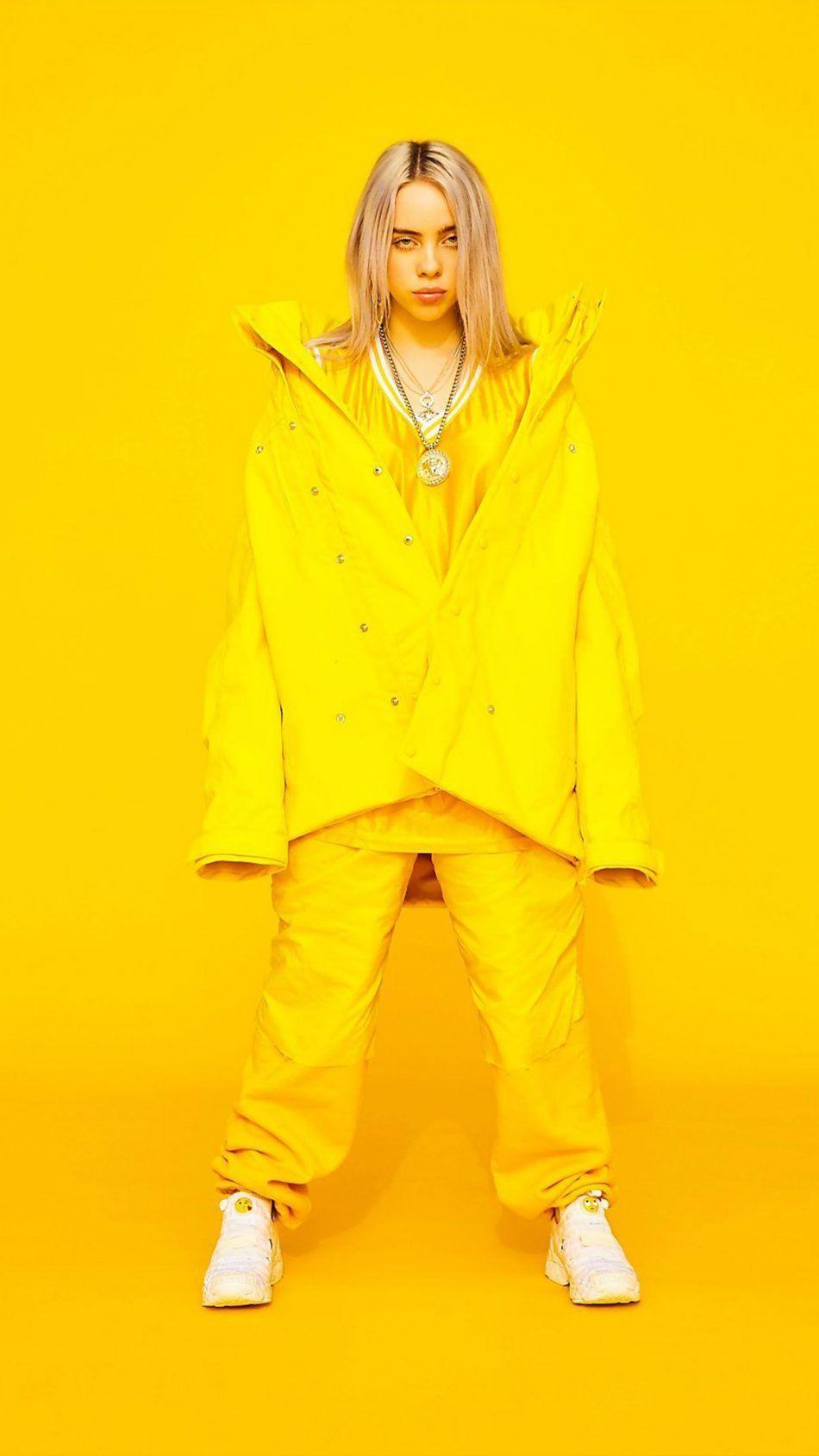 950x1689 Billie Eilish Yellow Background 4K Ultra HD Mobile Wallpaper