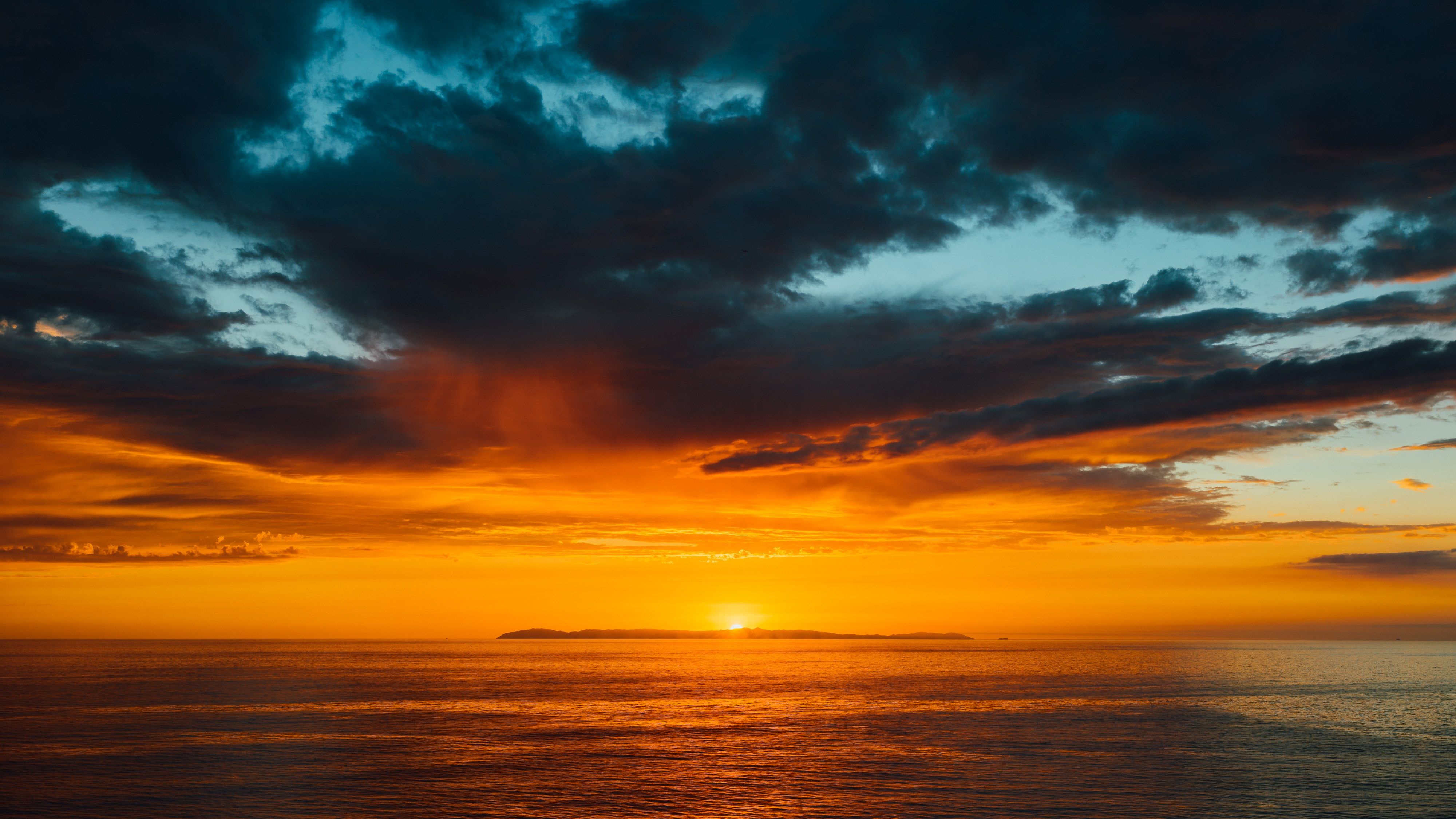 4000x2250 Download wallpaper 4000x2250 sea, horizon, sunset, clouds, sun, sky, dark HD background