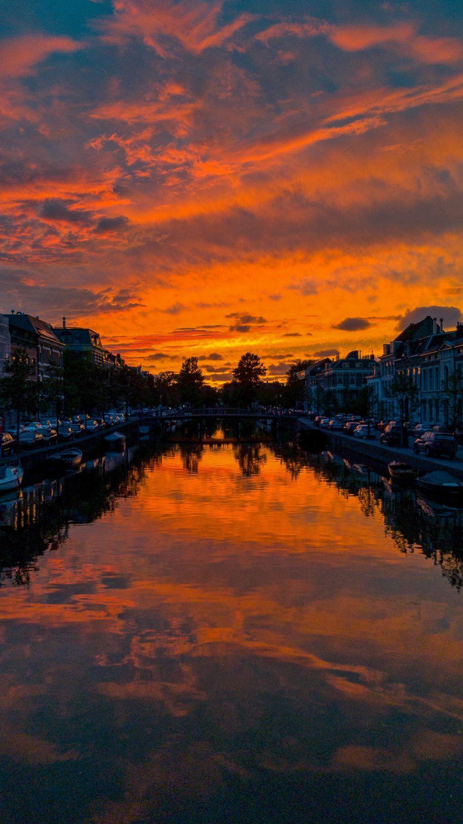 938x1668 Download wallpaper 938x1668 river, sunset, canal, city