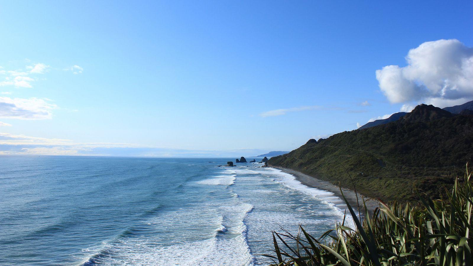 1600x900 Download wallpaper 1600x900 new zealand, sea, mountain, beach widescreen 16:9 HD background
