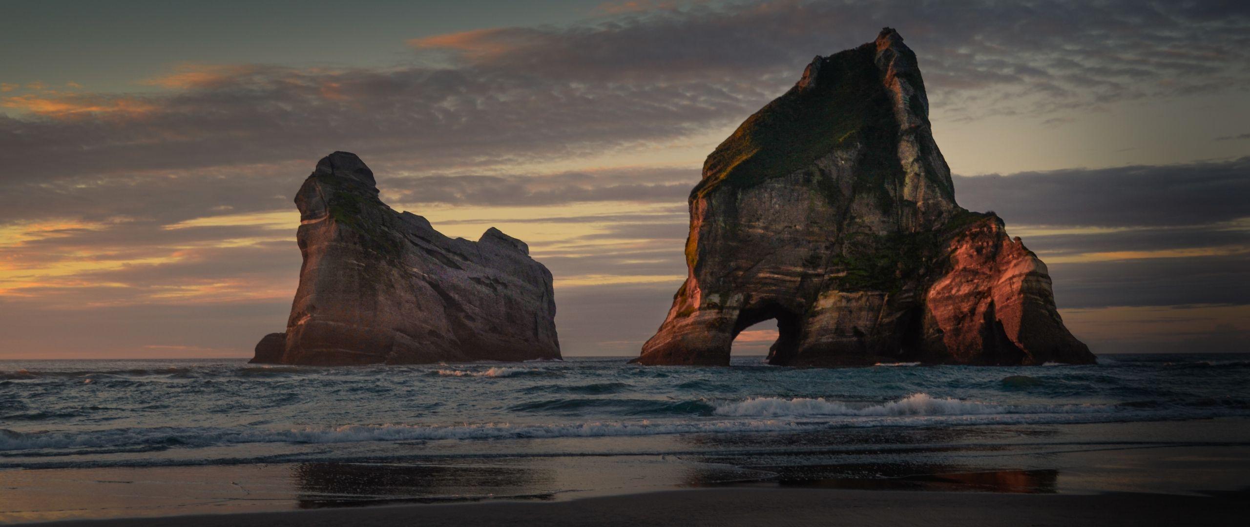 2560x1080 Download 2560x1080 wallpaper new zealand, beach, arc, cliff, sunset, dual wide, widescreen, 2560x1080 HD image, background, 10112