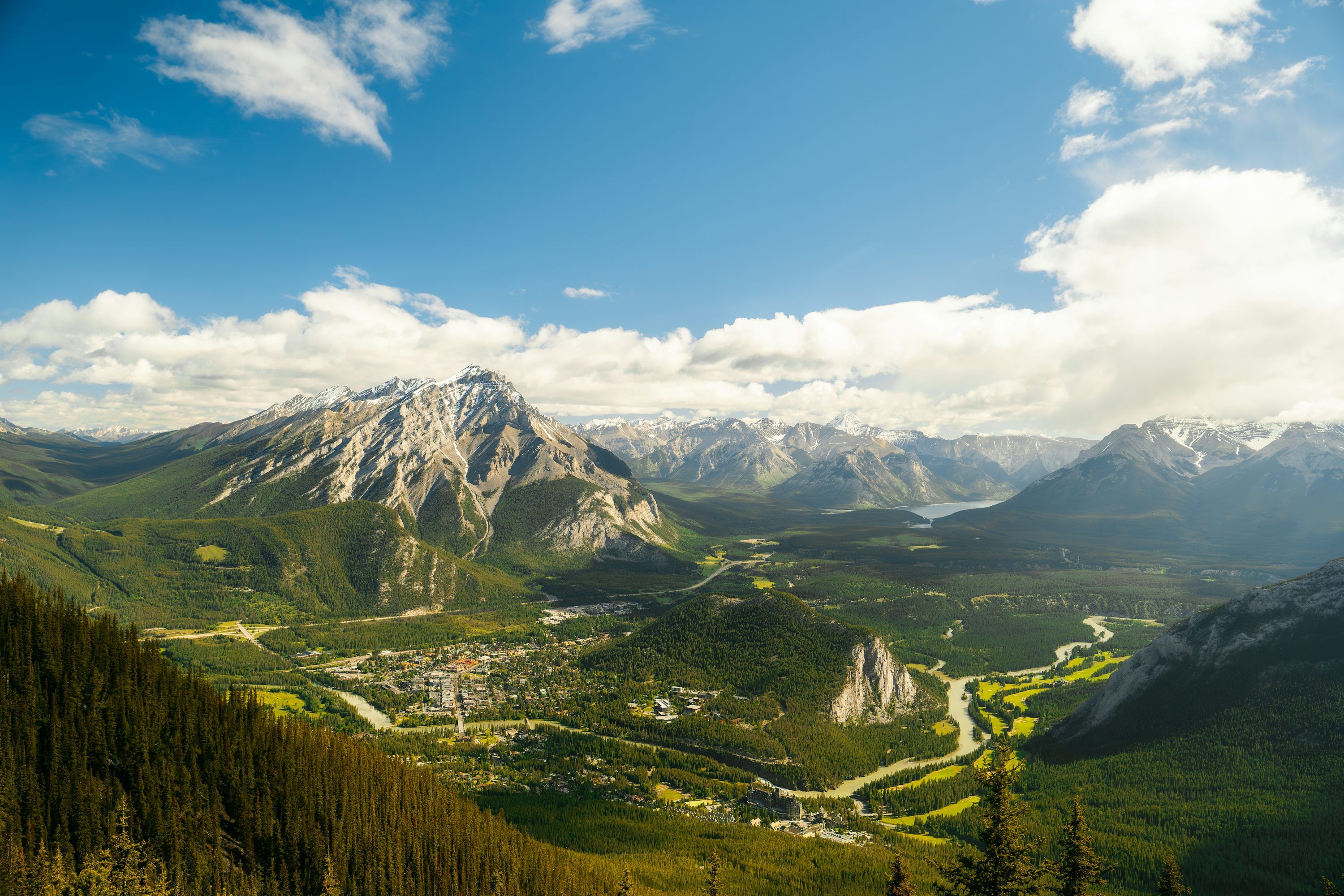 3000x2000 A scenic view of a mountain range with trees and mountains in the background photo