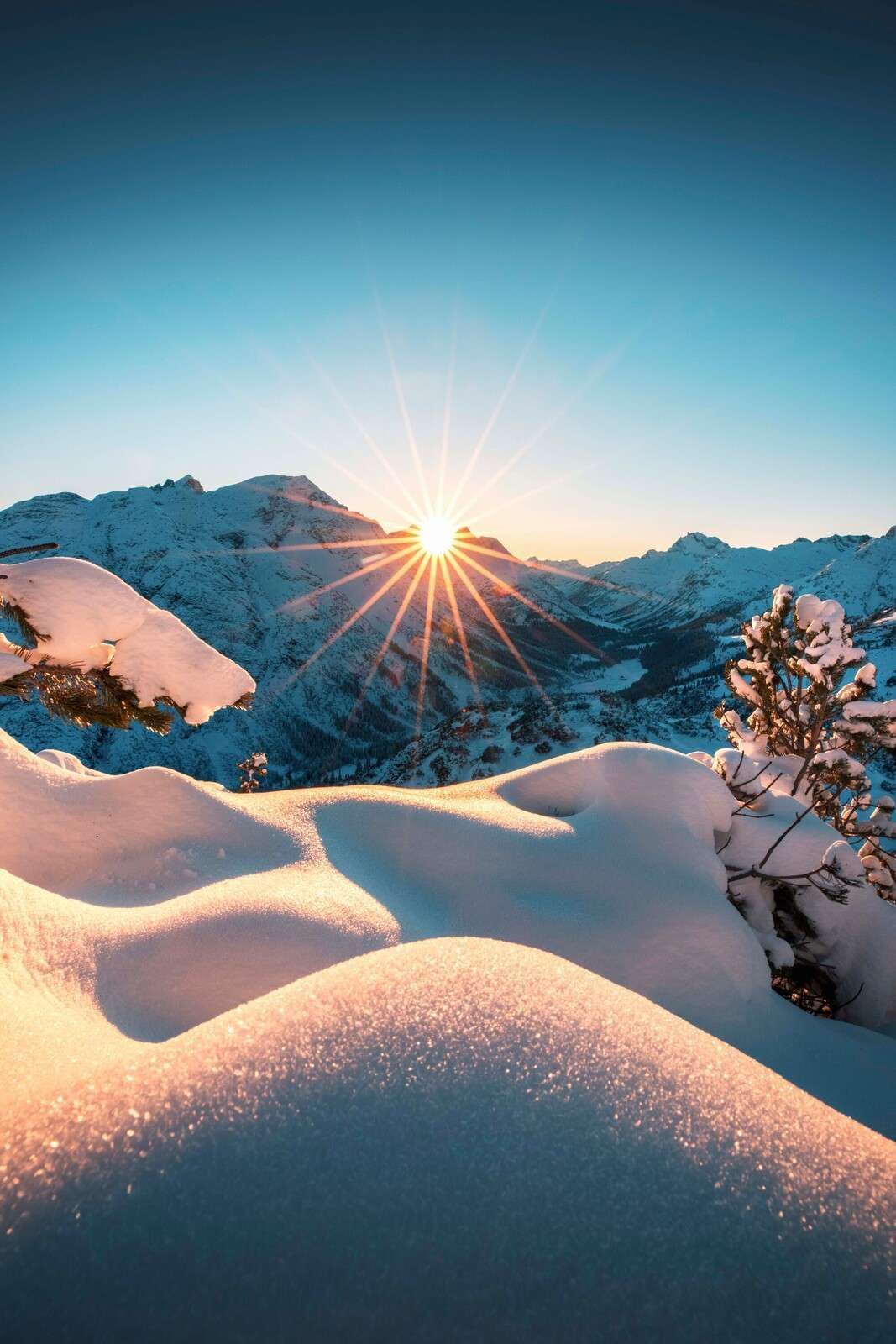 1067x1600 Wall Mural Sun Over Snow Covered Valley
