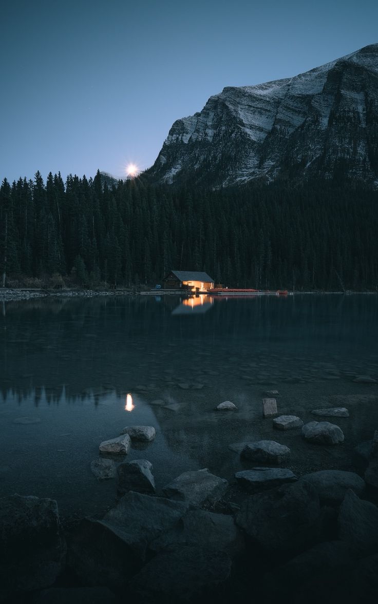736x1177 Wallpaper lake house coast mountain forest night