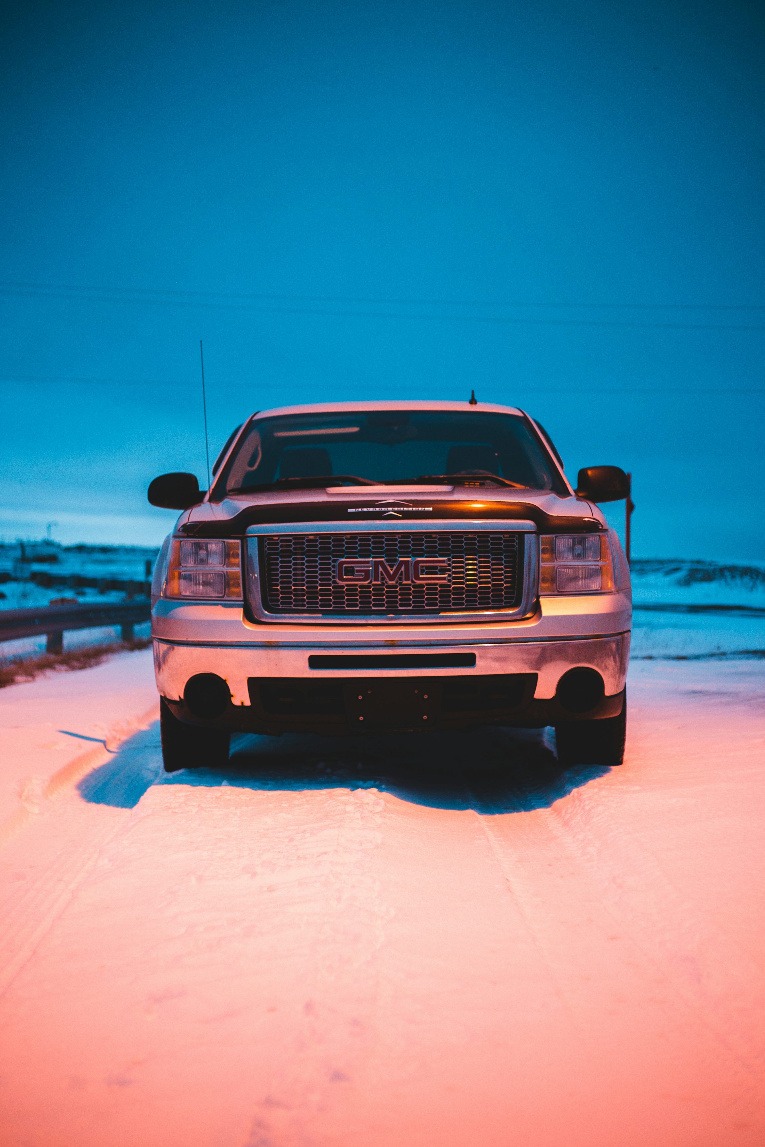3000x4500 Parked black GMC truck on snowfield photo