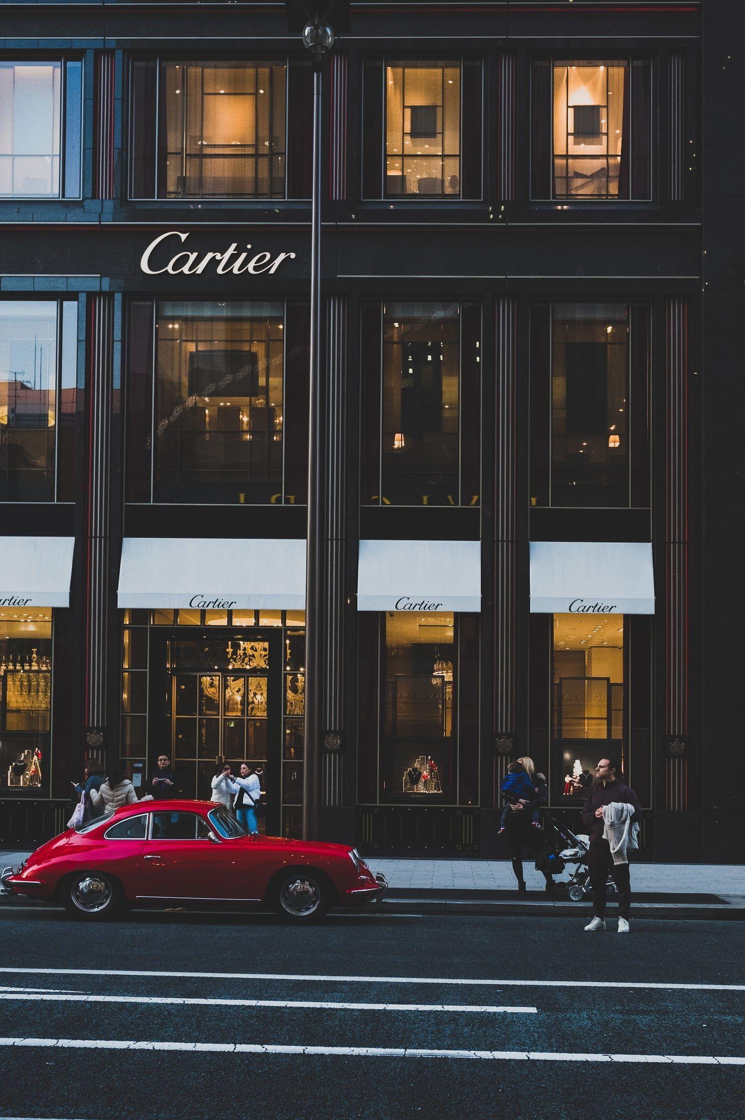 1481x2224 red coupe infront of cartier shop, people outside Cartier building