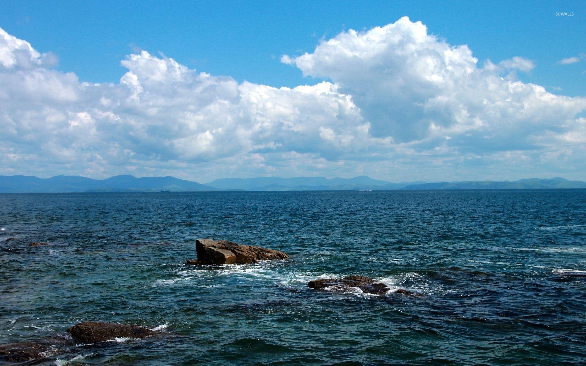 1920x1200 Fuzzy clouds over the rocky ocean wallpaper wallpaper