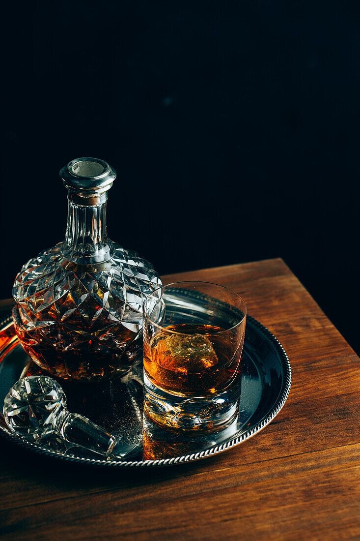 733x1100 Glass of cold whiskey with ice placed on