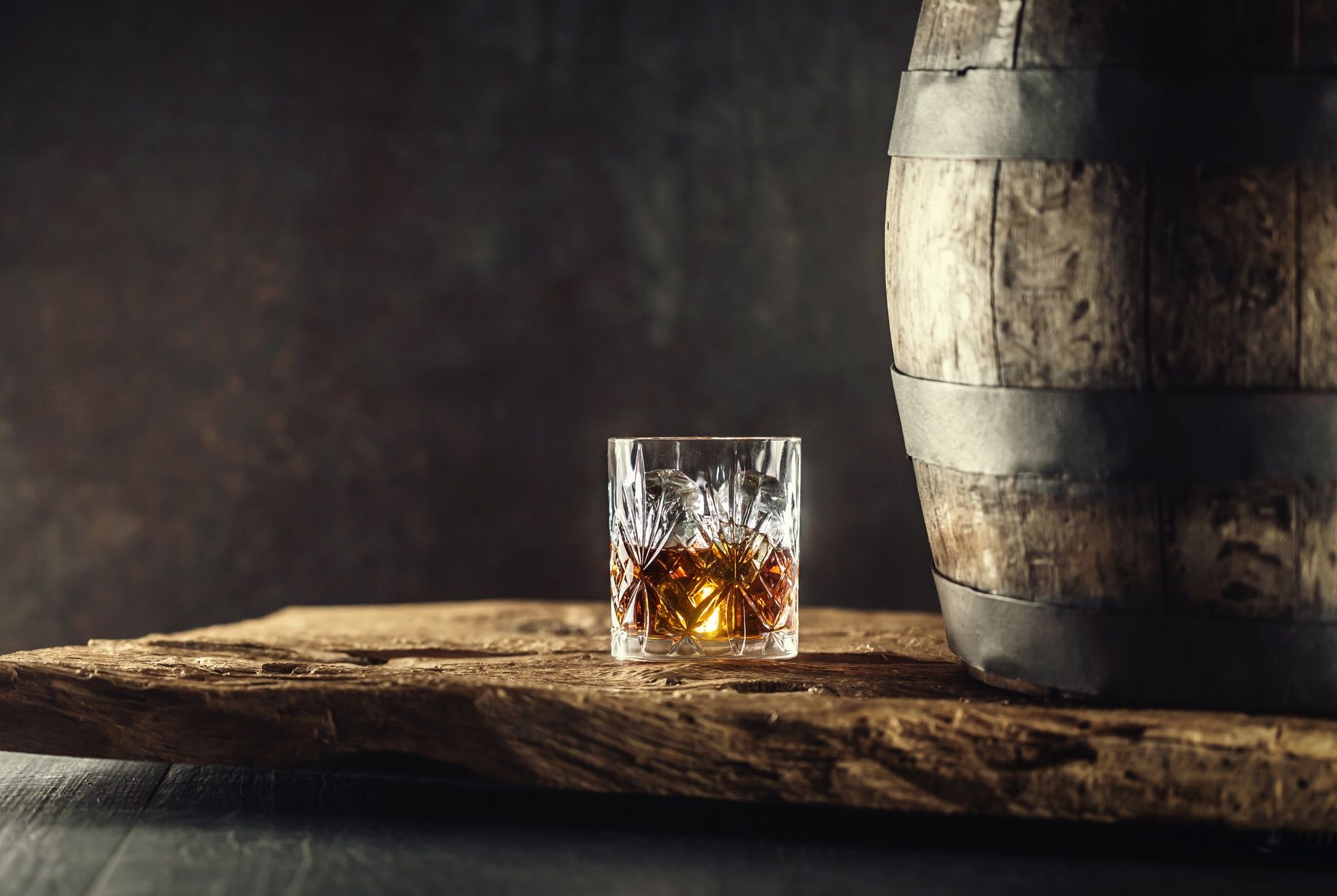 1832x1228 Glass of whisky or bourbon in ornamental glass next to a vinatge wooden barrel on a rustic wood and dark background Chamber of Commerce