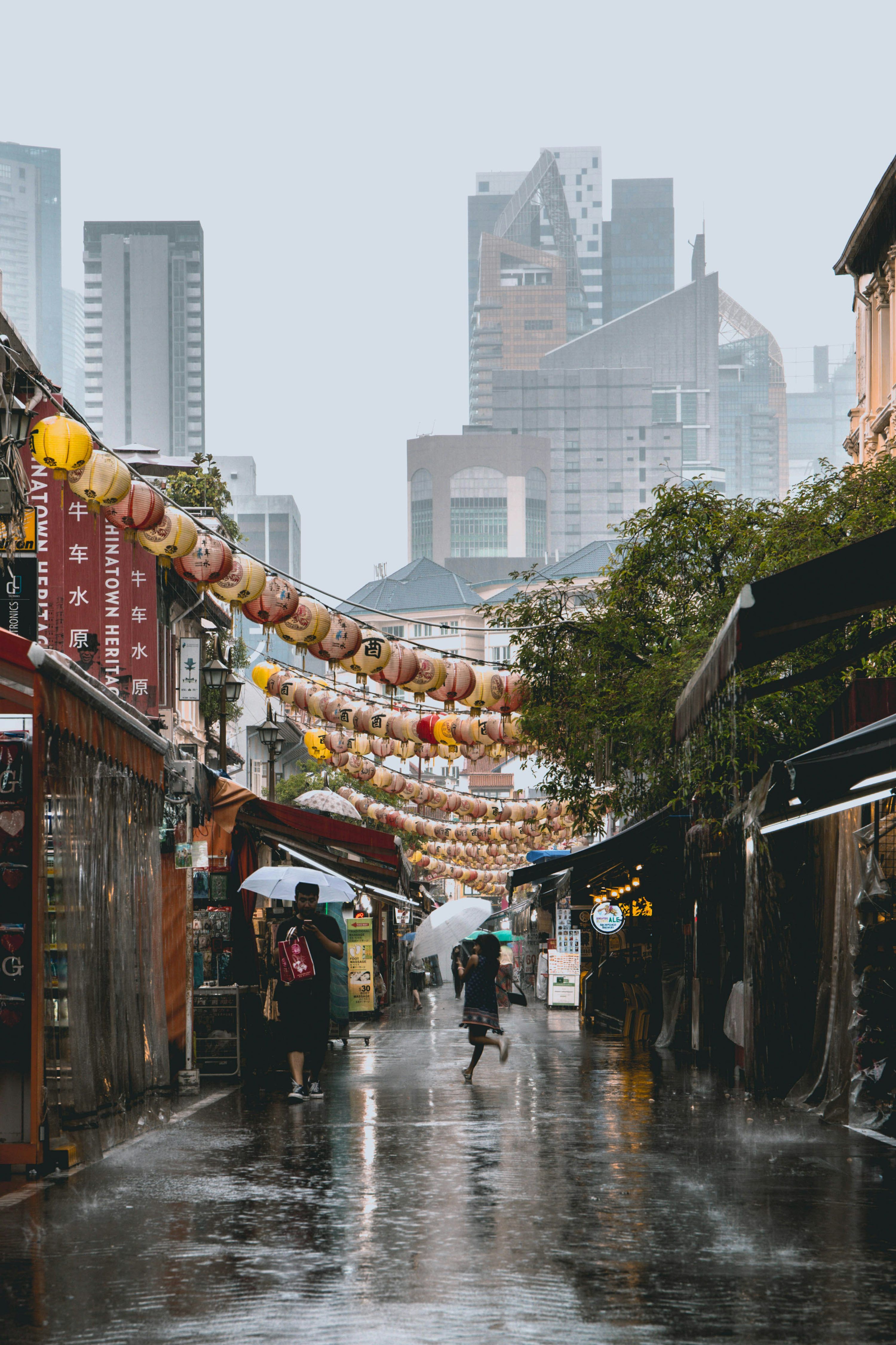 3000x4501 Person holding umbrella walking on road photo