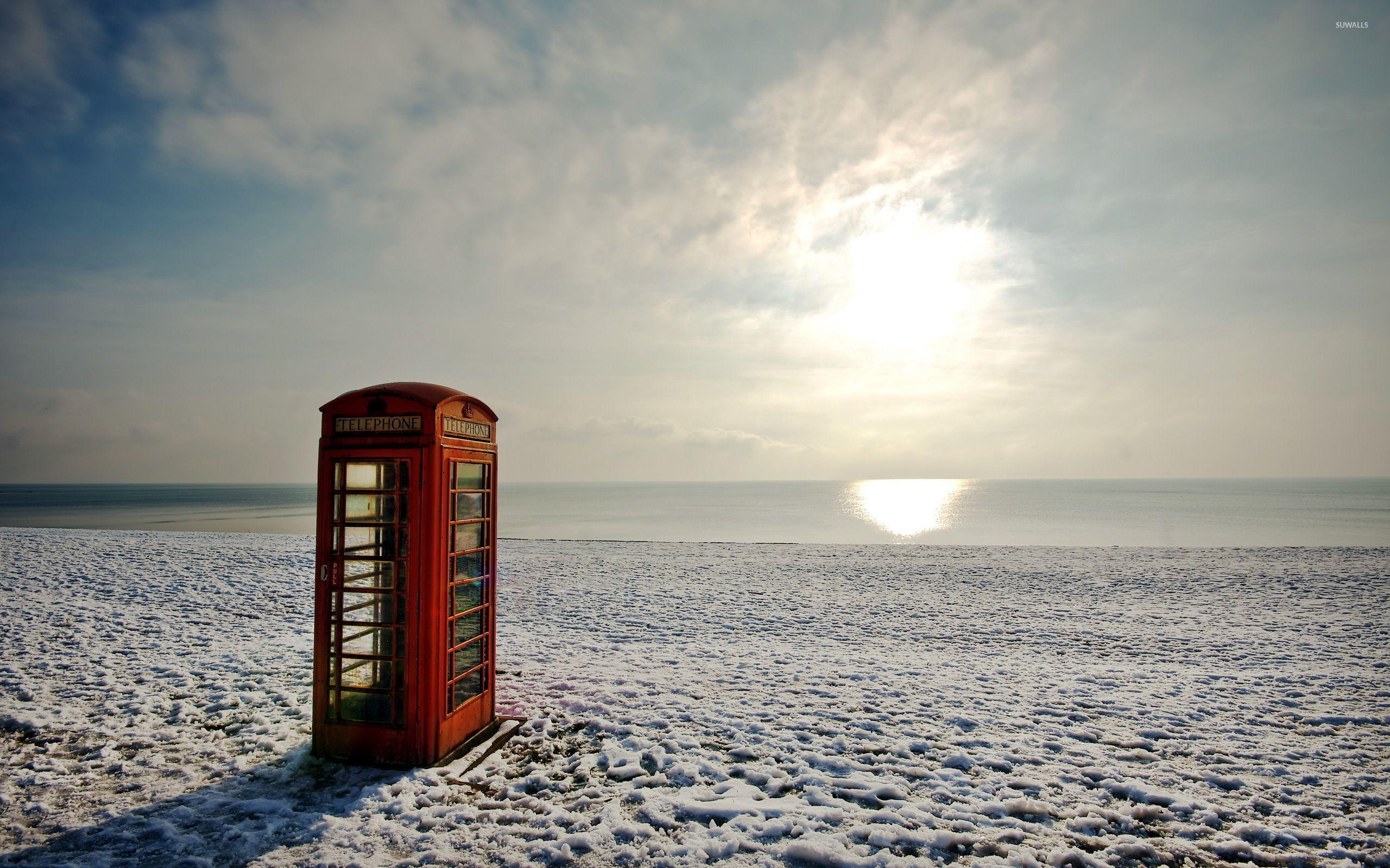 2560x1600 Red telephone booth on a winter beach wallpaper wallpaper