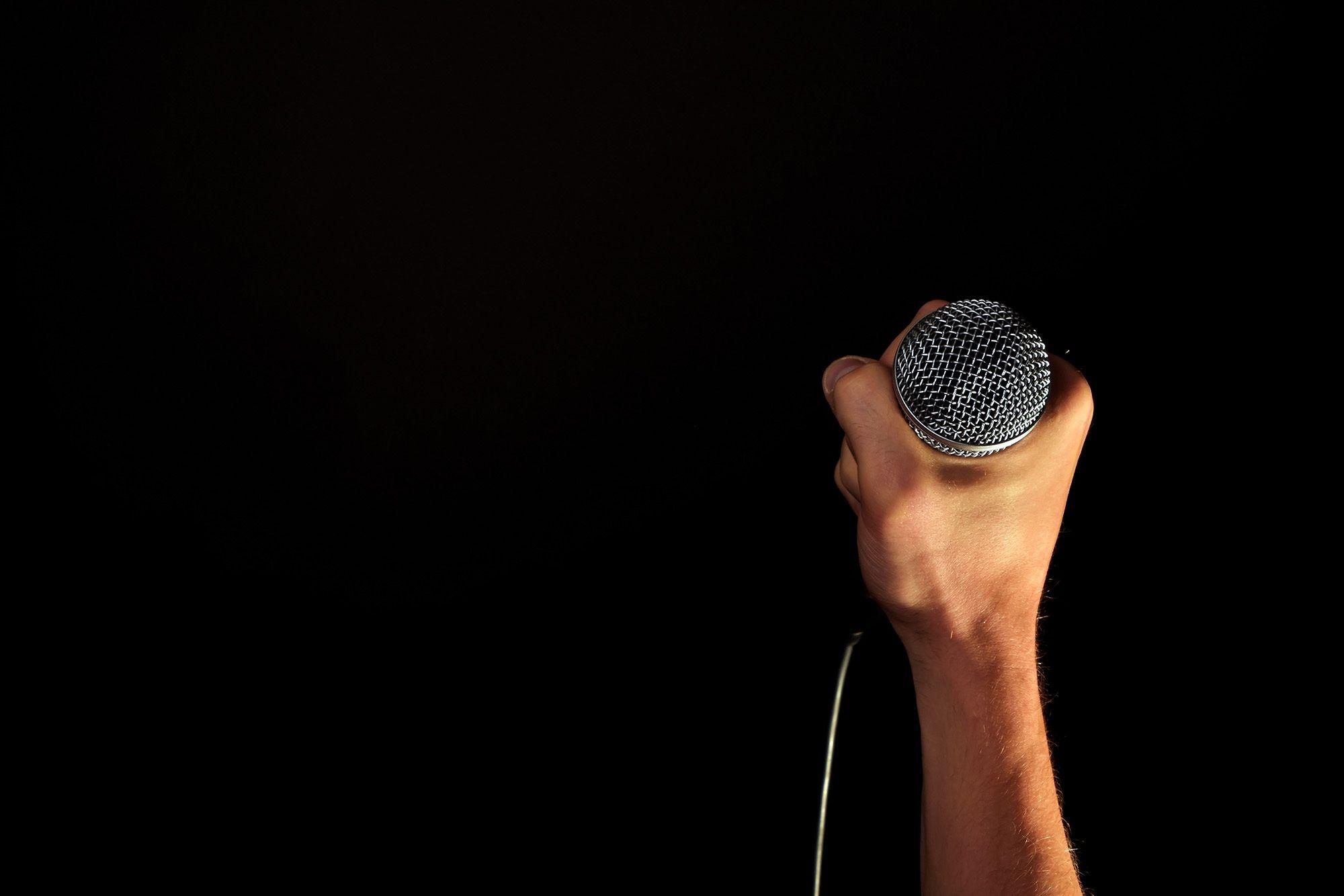 2000x1334 Person Holding Microphone · Free