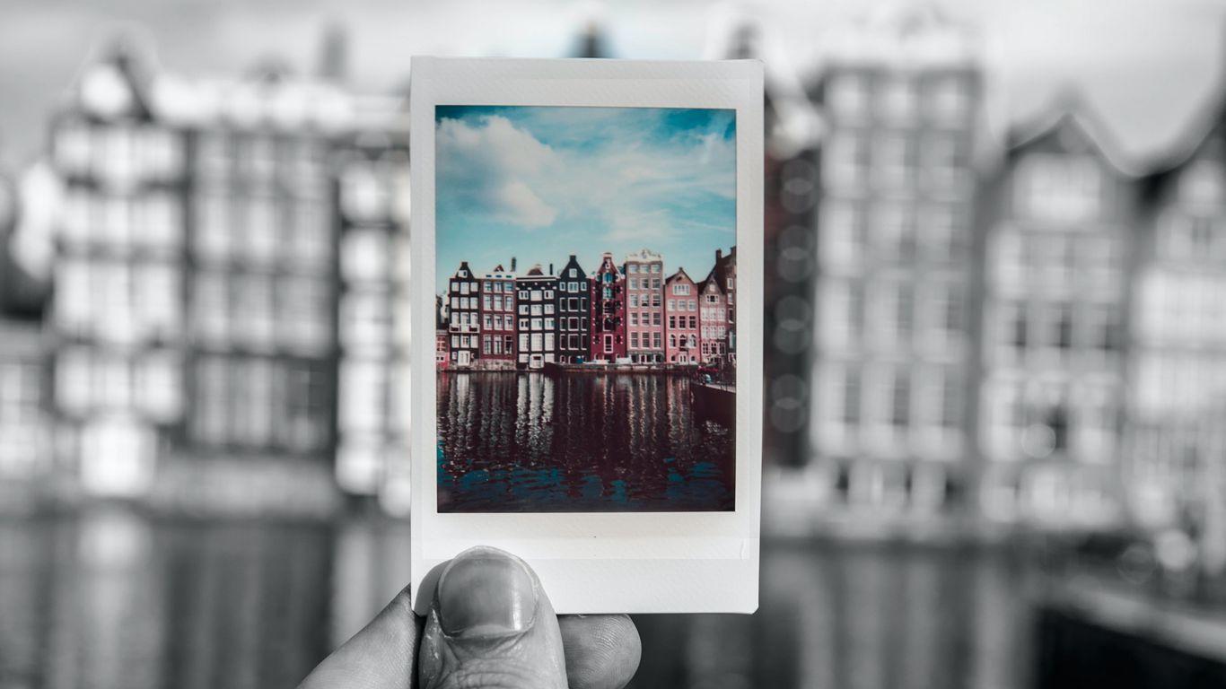 1366x768 Download wallpaper 1366x768 photography, polaroid, hand, bw tablet