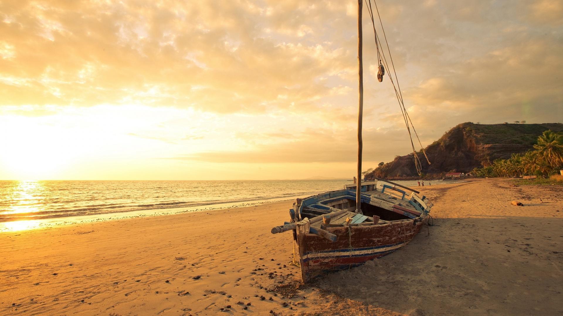 1920x1080 Old Sailboat On A Beautiful Beach At Sunset HD desktop wallpaper