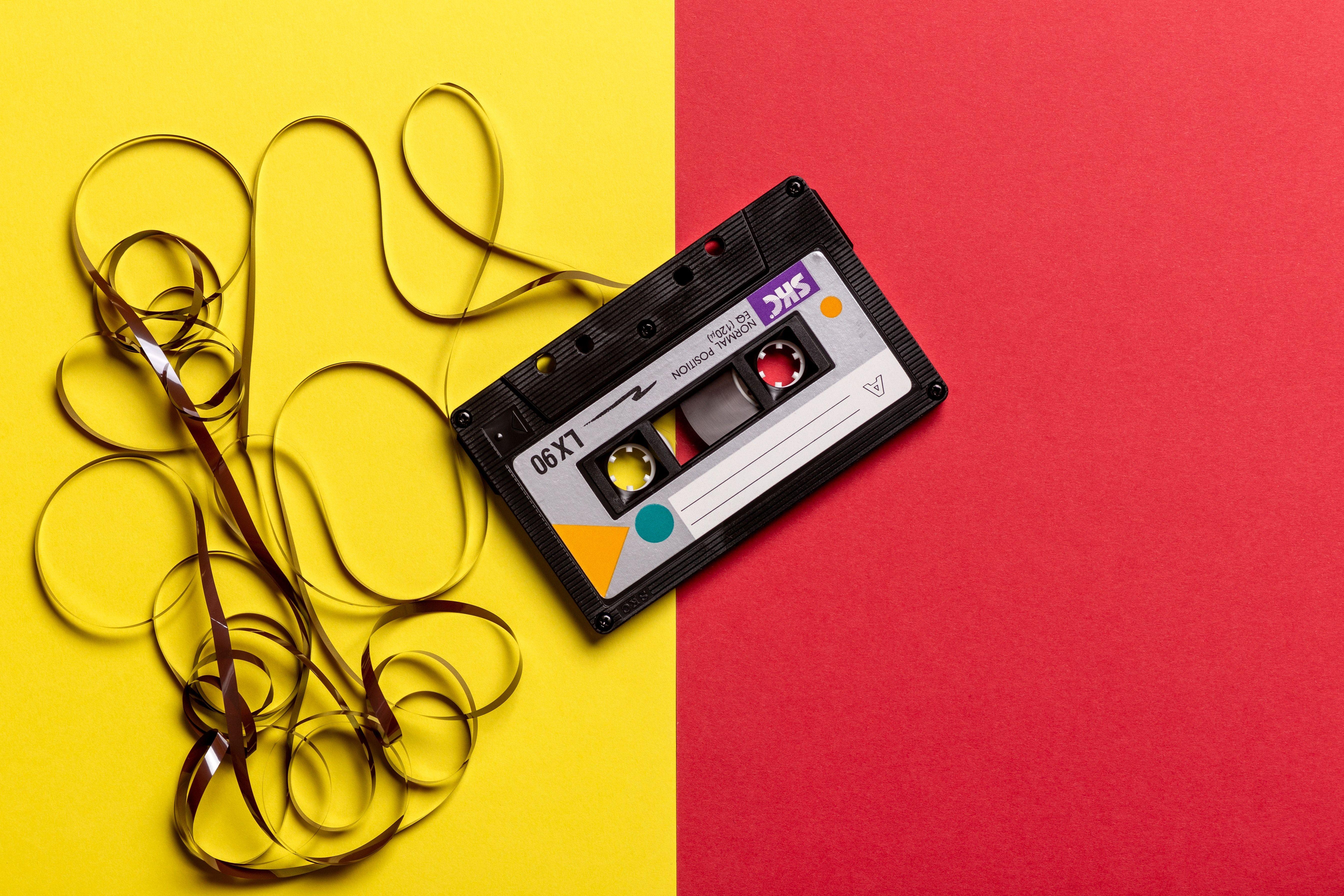 5377x3585 Black Cassette Tape on Top of Red and Yellow Surface · Free