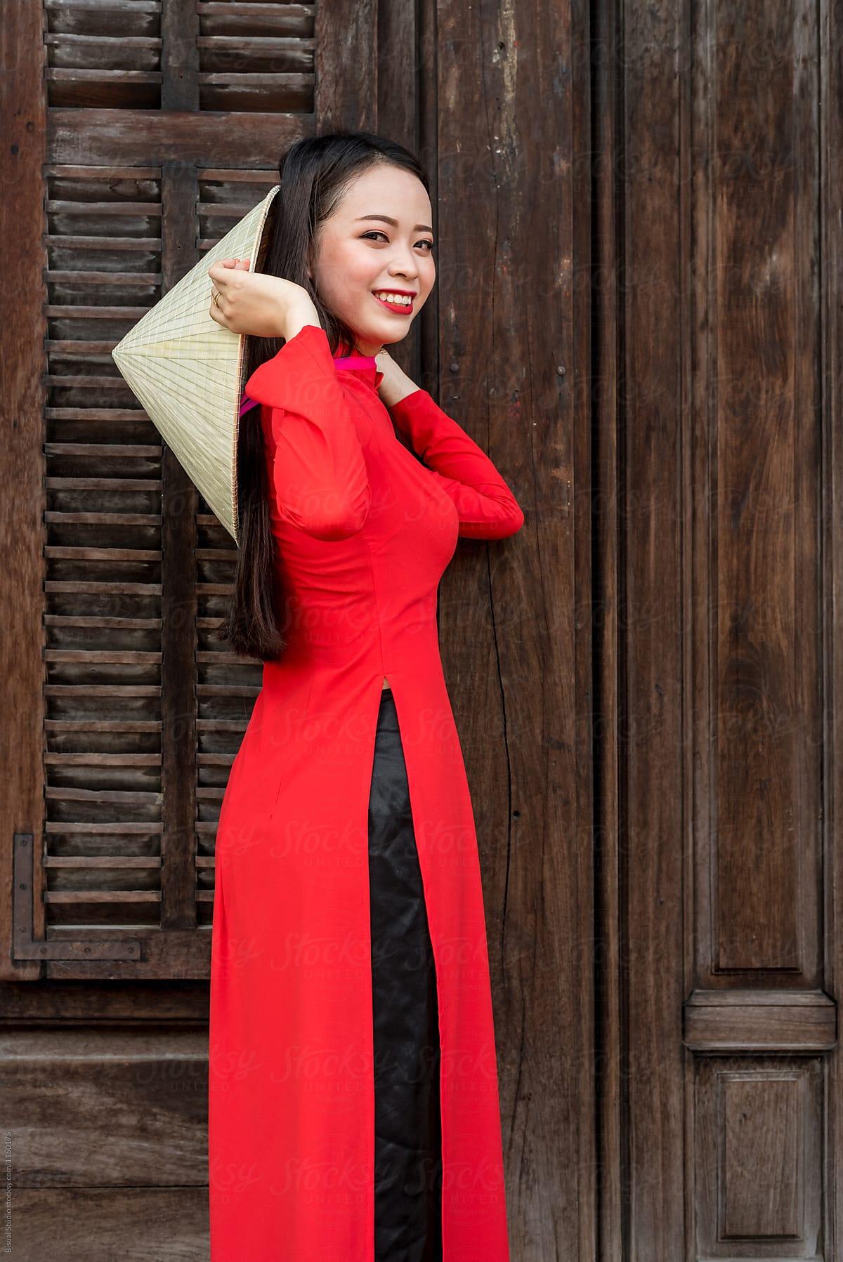 1200x1797 Vietnamese woman in red Ao Dai, traditional costume, and conical