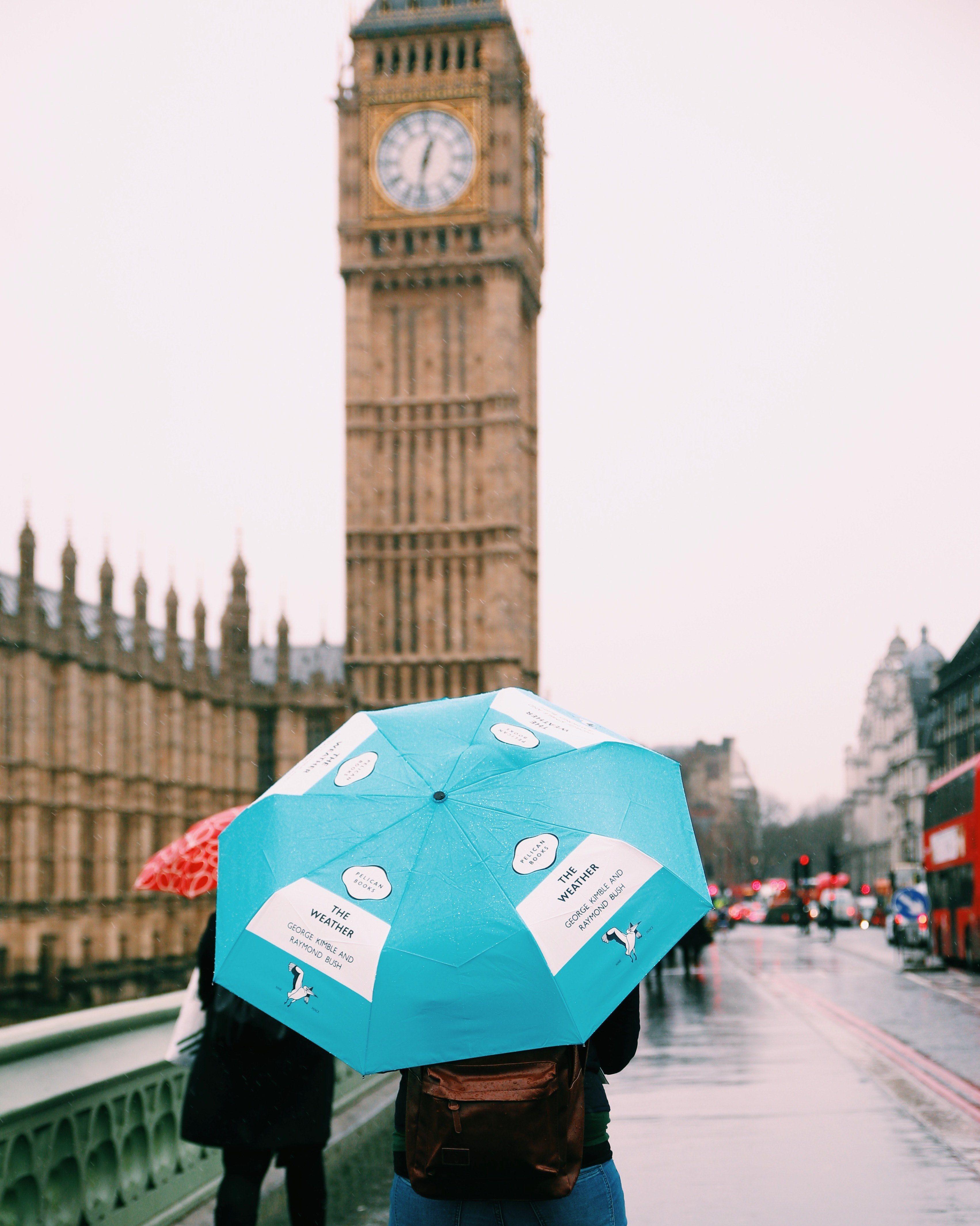 3405x4257 Wallpaper / person carries a blue umbrella down a rainy london street, big ben in the rain 4k wallpaper