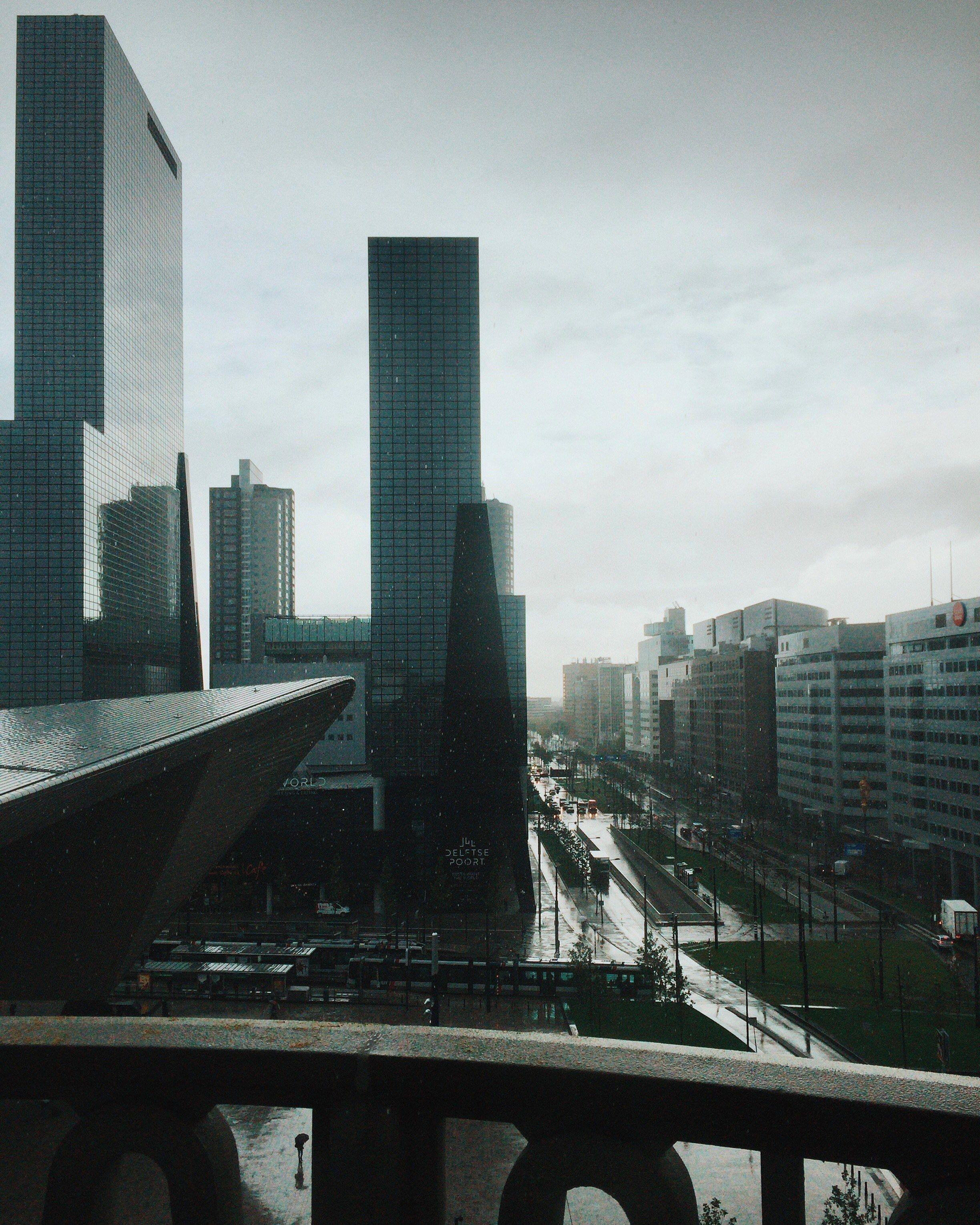 2448x3060 Wallpaper / the business district in rotterdam on a rainy day, business district in the rain 4k wallpaper