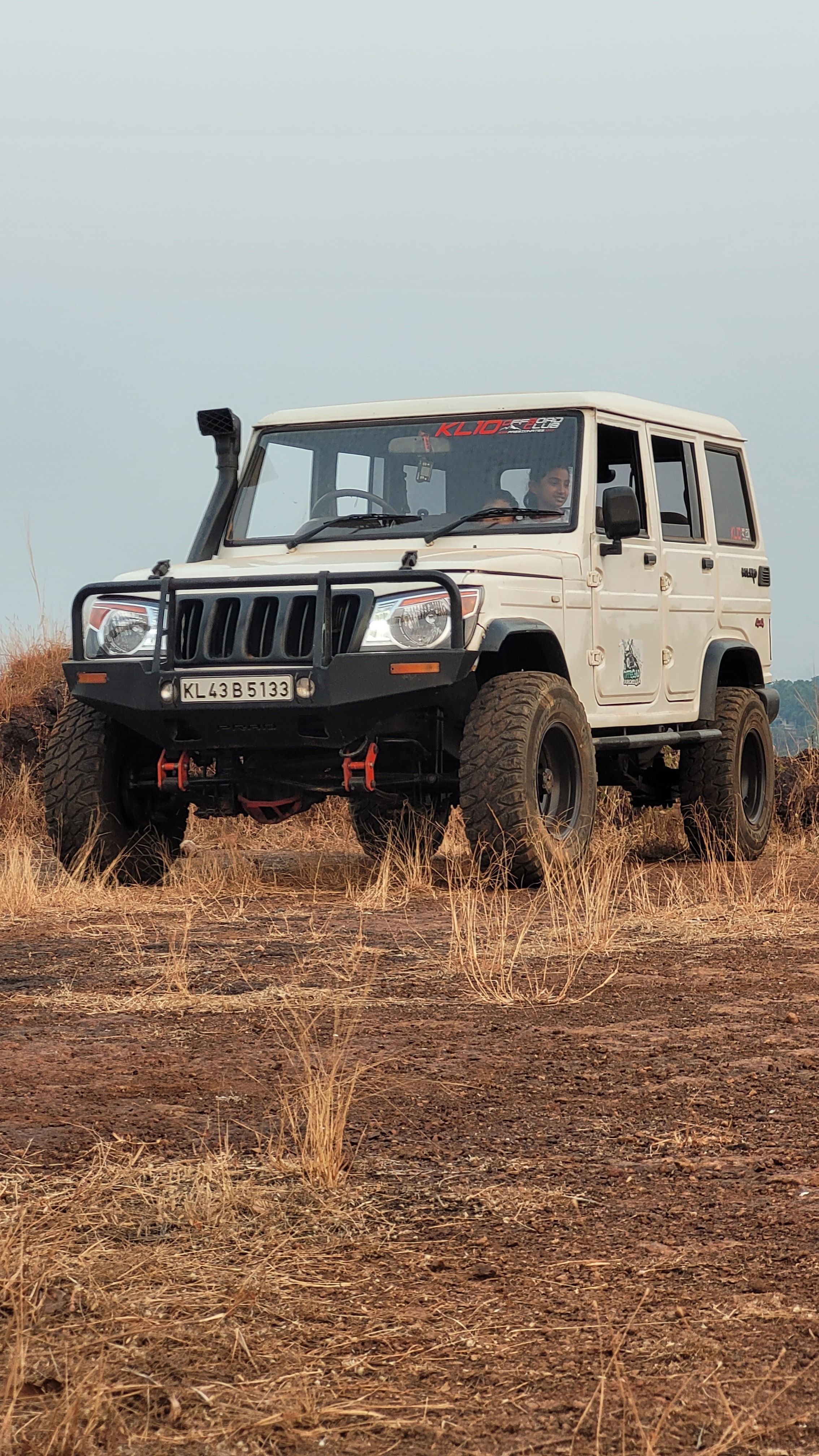 2268x4032 A Person Driving a Mahindra Bolero 4x4 SUV · Free