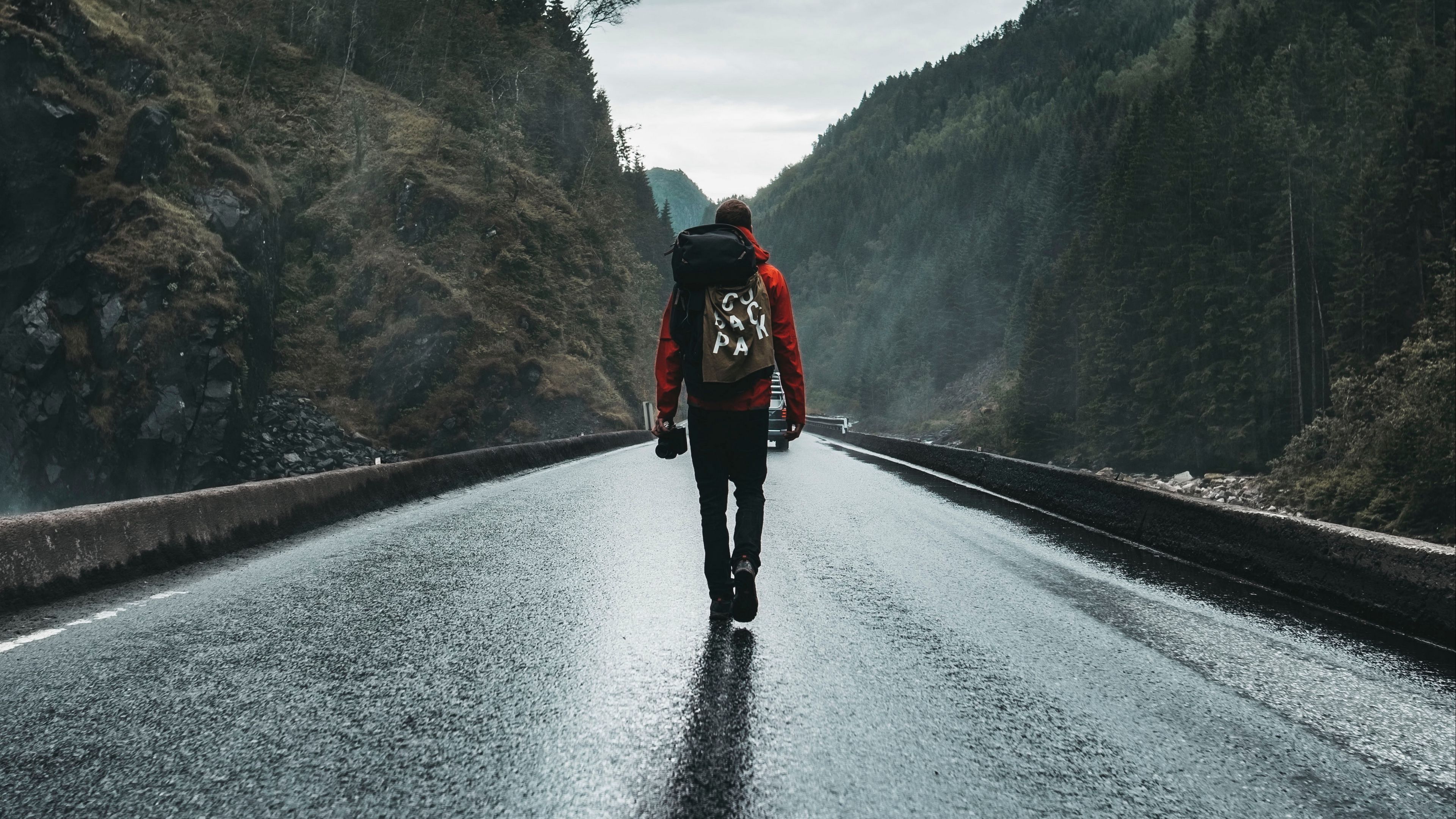 3840x2160 Man Is Walking Alone On Road Between Mountains 4K HD Alone Wallpaper