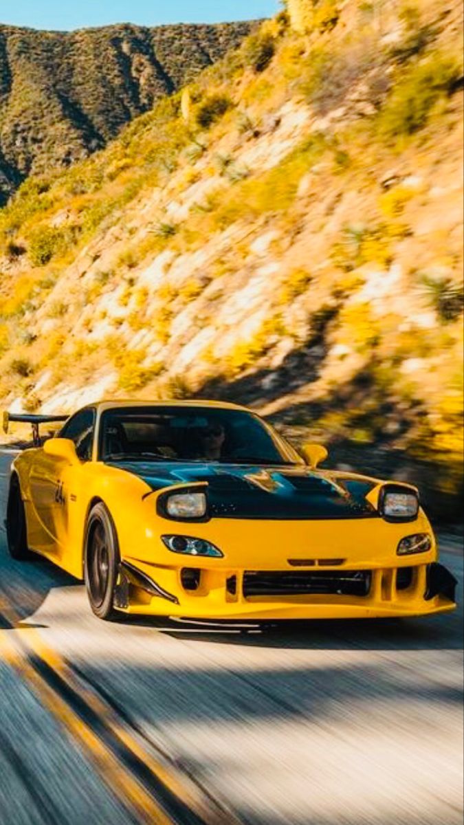 675x1200 Yellow Sports Car Driving Through Scenic Landscape. Dream car wallpaper ideas, Inspiration for car enthusiasts, Mountain road car photography