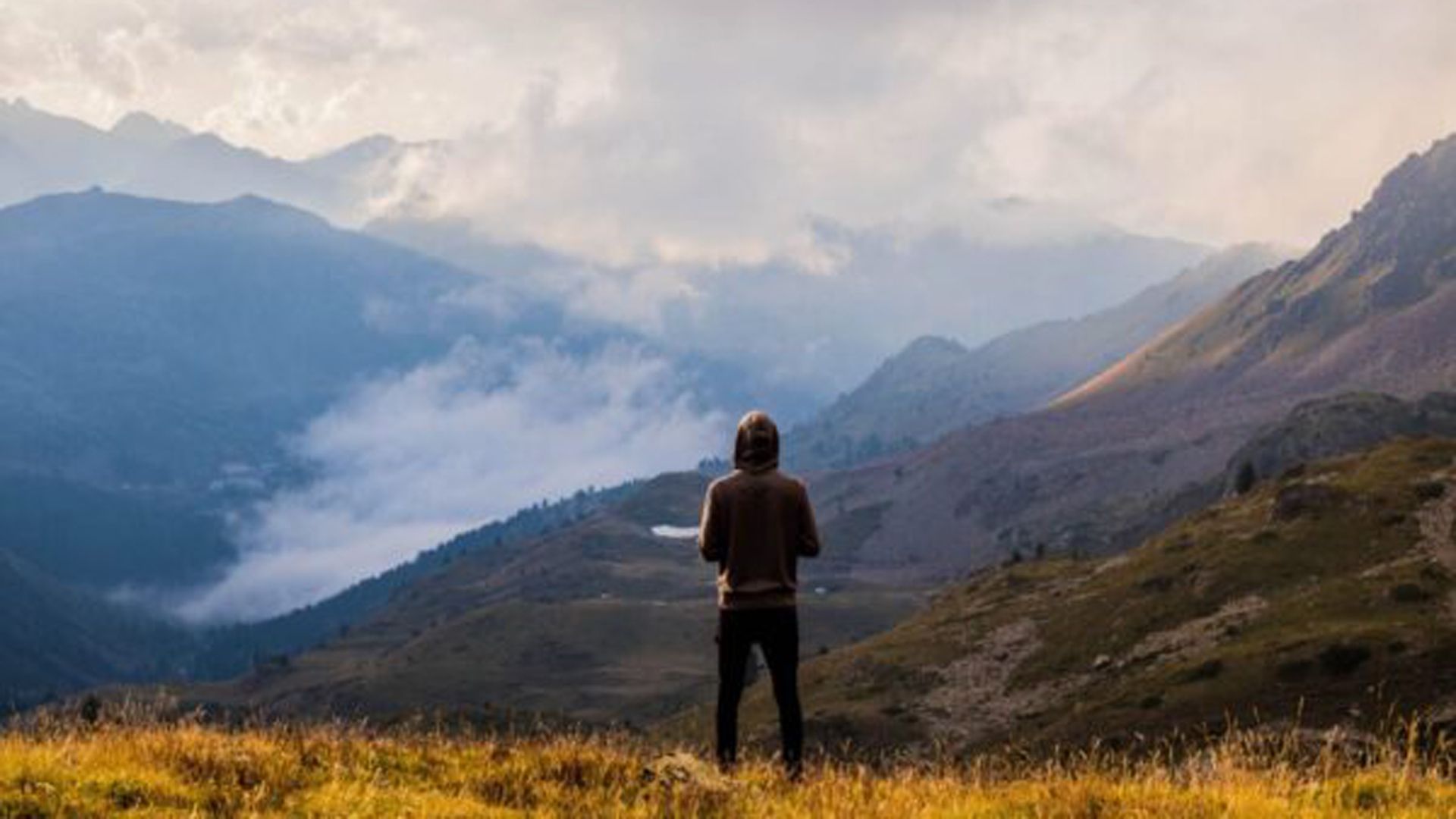1920x1080 Man Is Standing Alone On Green Grass Slope Mountain HD Alone Wallpaper