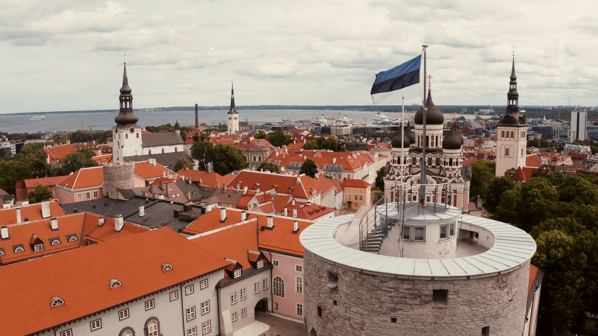 1920x1080 Estonian flag in the wind over the old city of Tallinn