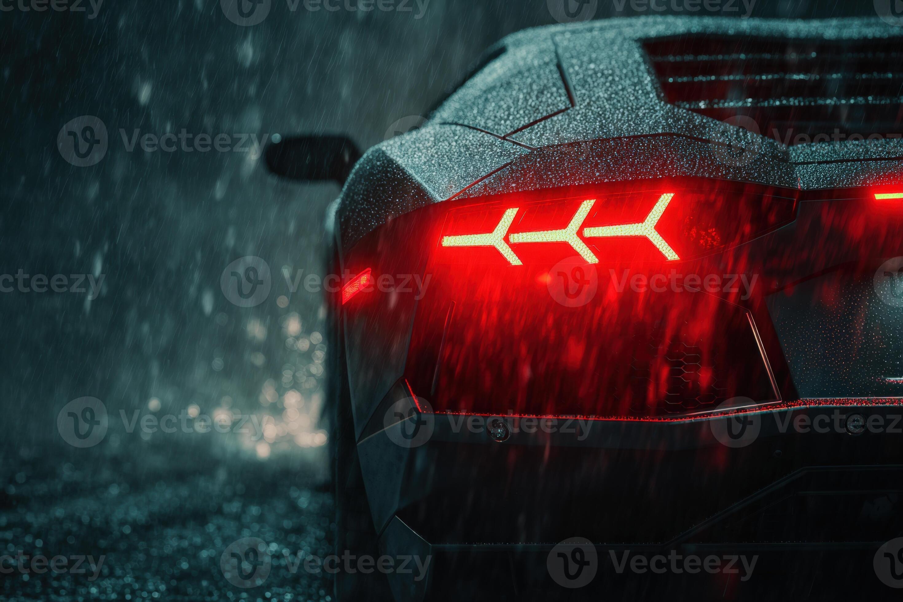 2940x1960 Moody black Lamborghini illuminated by red lights in heavy rain at night