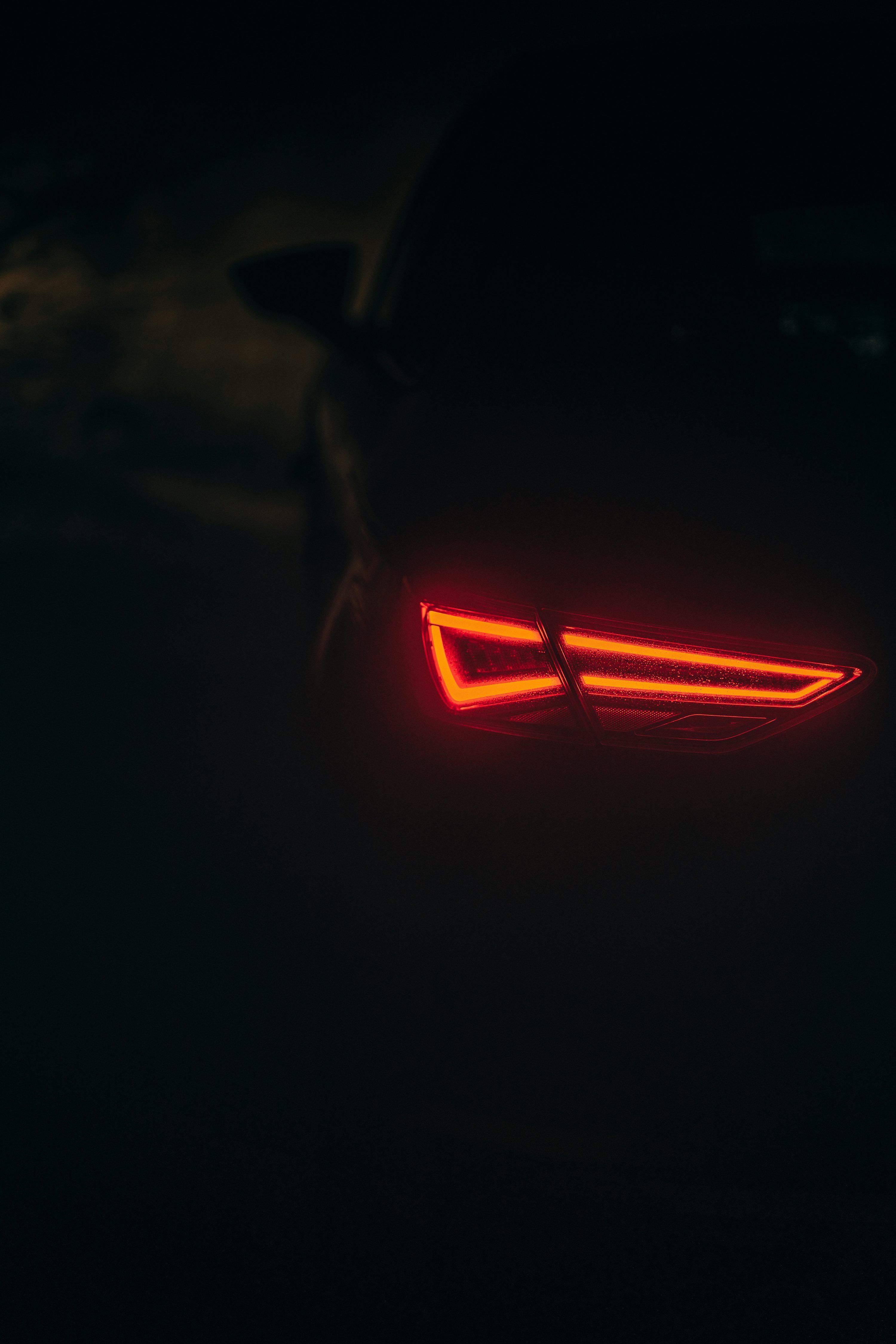 3000x4498 The tail light of a car in the dark photo