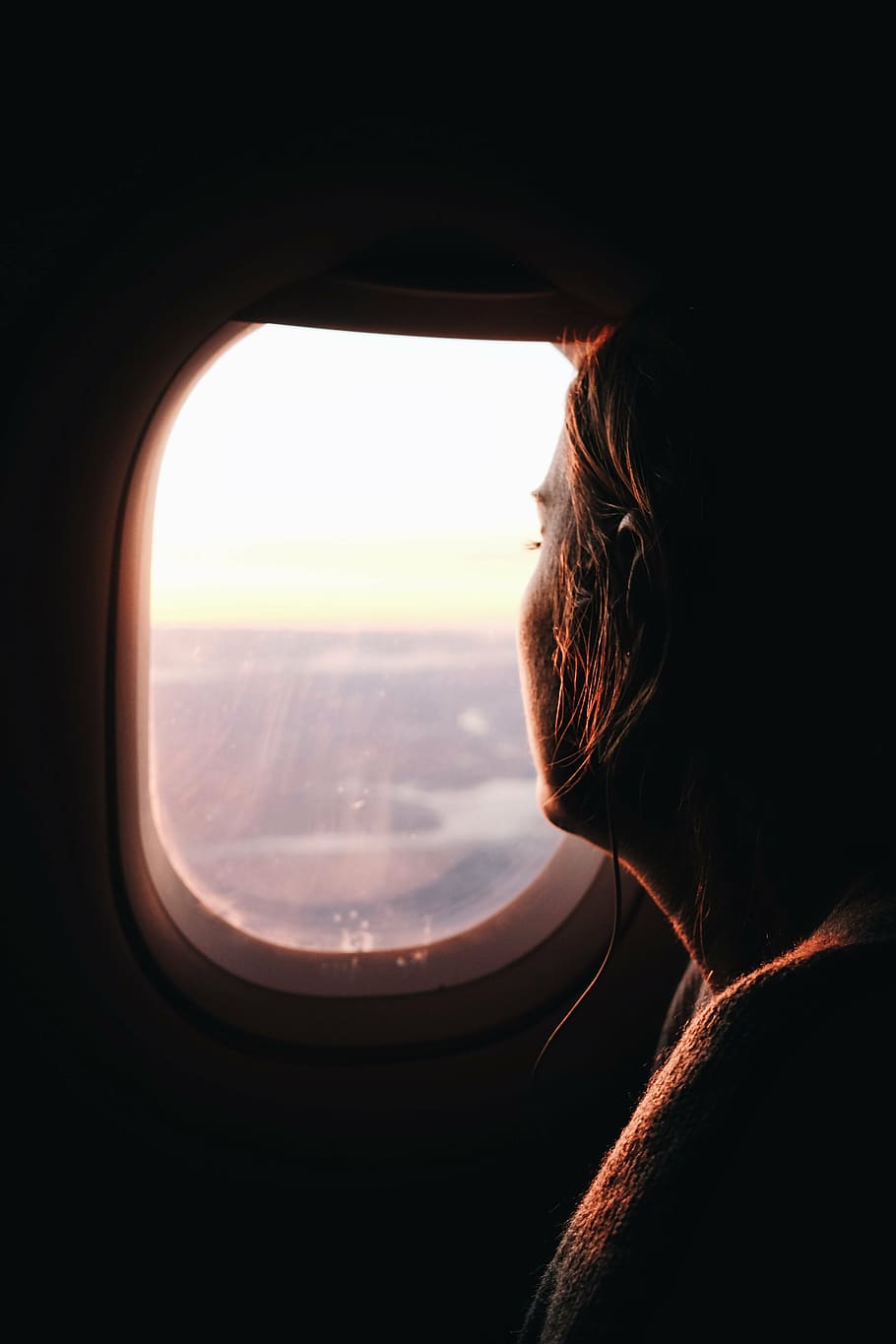 910x1365 HD wallpaper: woman looking at airplane window photo during daytime, blur, cord