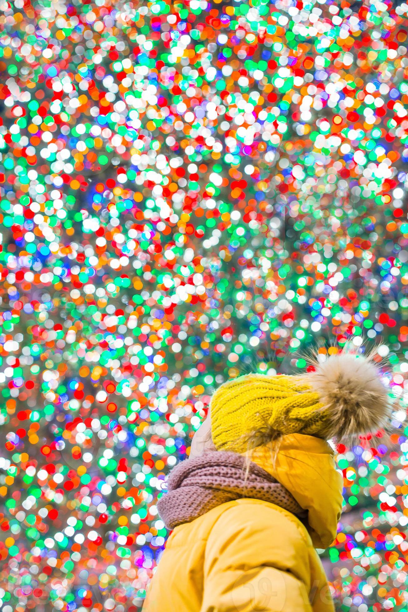 1307x1960 Happy girl on the background of the Rockefeller Christmas tree in New York