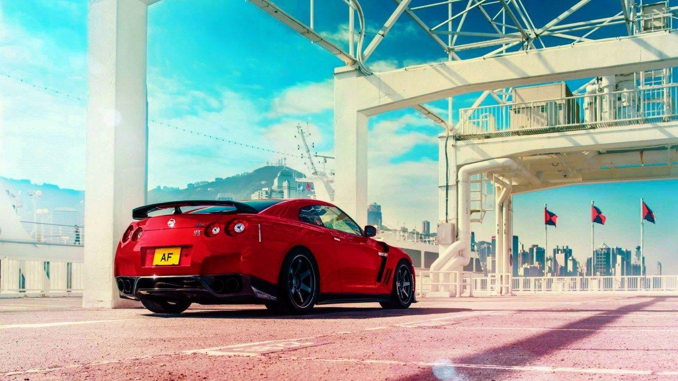 1366x768 HD Background Nissan GT R Red Color Rear View Sportscar Wallpaper