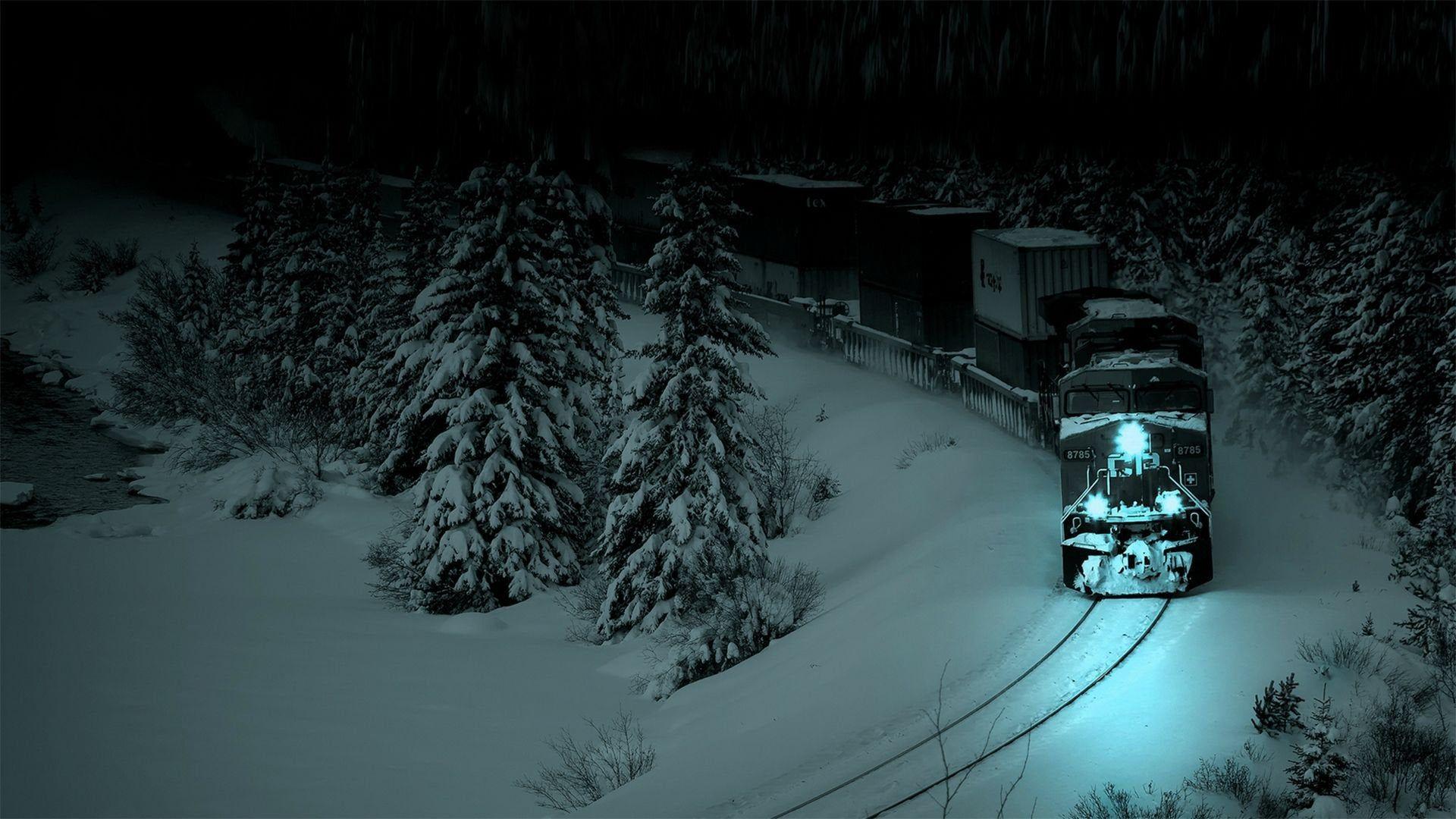 1920x1080 A train traveling through a snowy forest at night. [1920x1080]