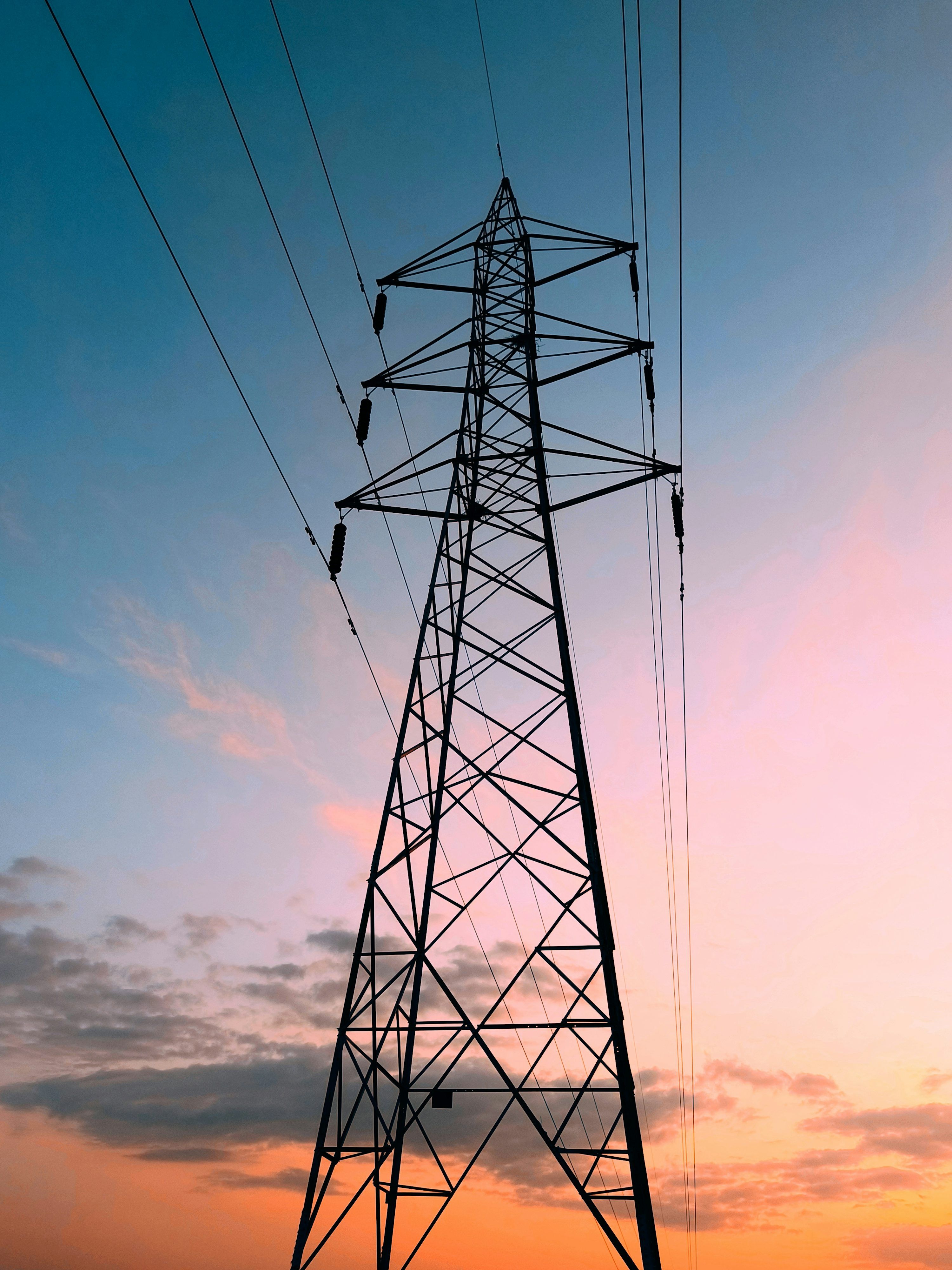 3000x4000 A high voltage power line with a sunset in the background photo