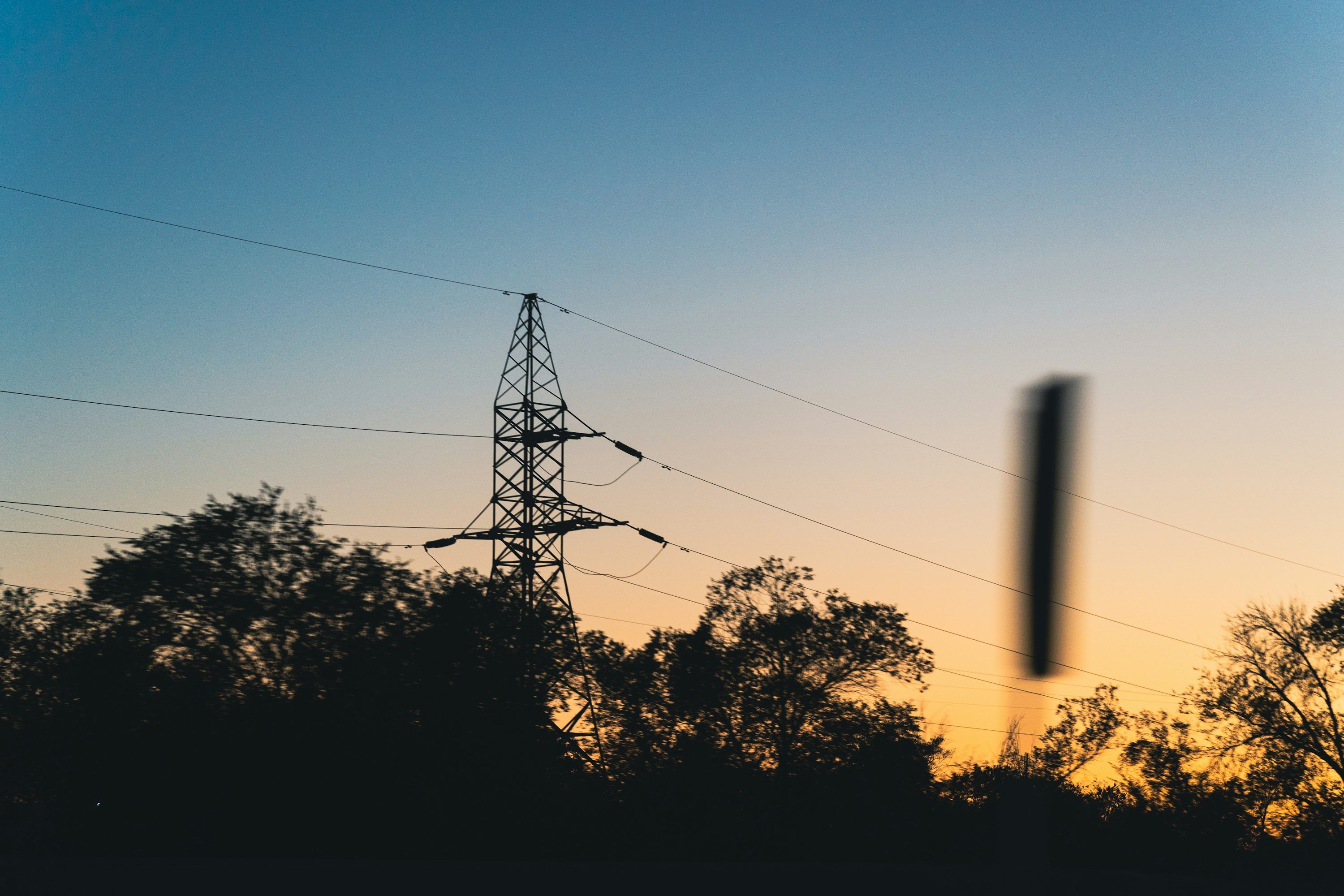 3000x2000 A blurry photo of a telephone pole and trees photo
