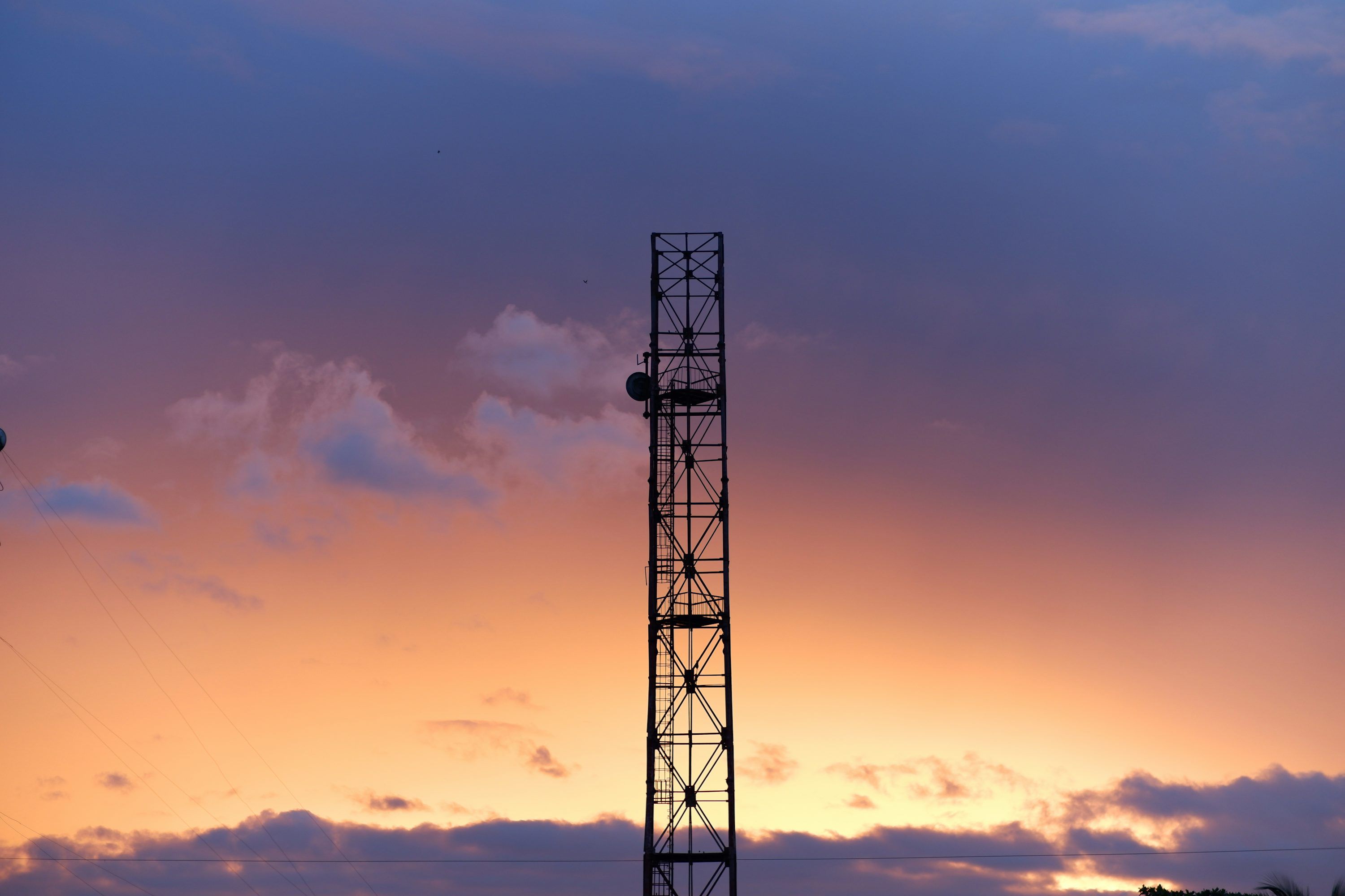 3000x2000 A tower with a sunset in the background photo