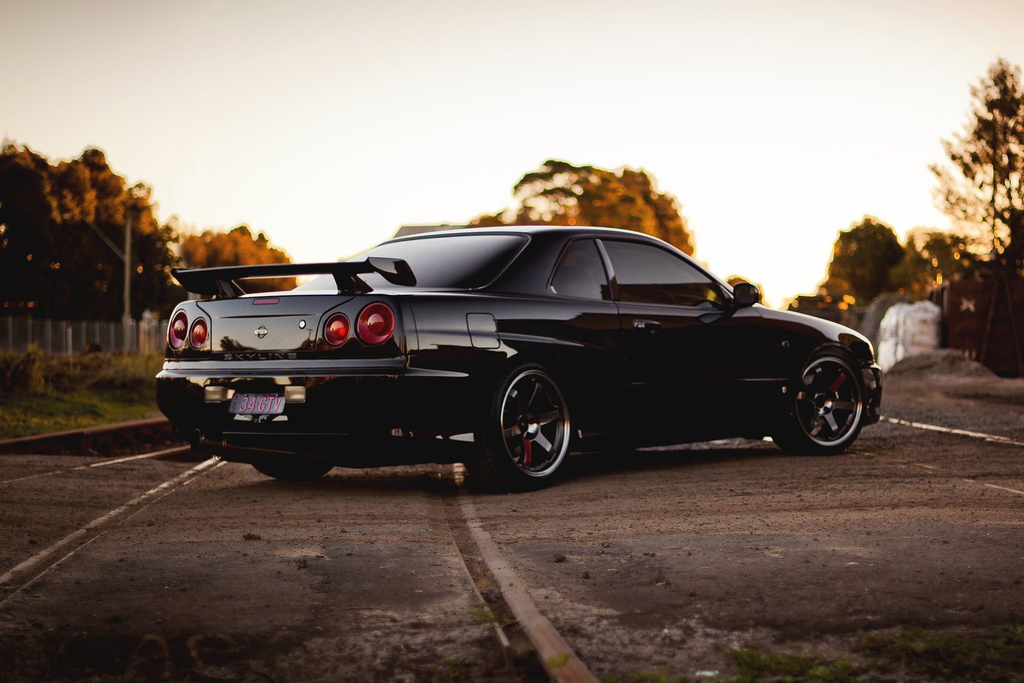 2100x1400 HD wallpaper: black coupe, railroad, skyline, r nissan, gtr, side view, car