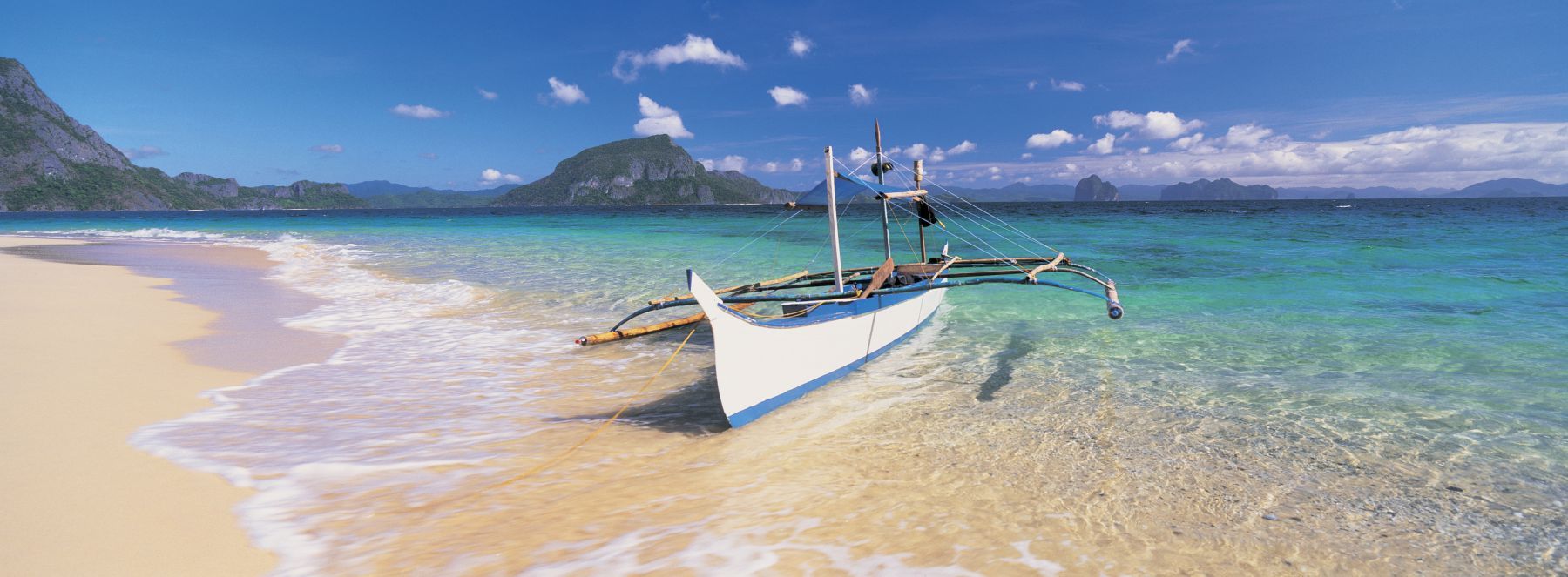 1800x663 Fishing boat moored on the beach, Palawan, Philippines