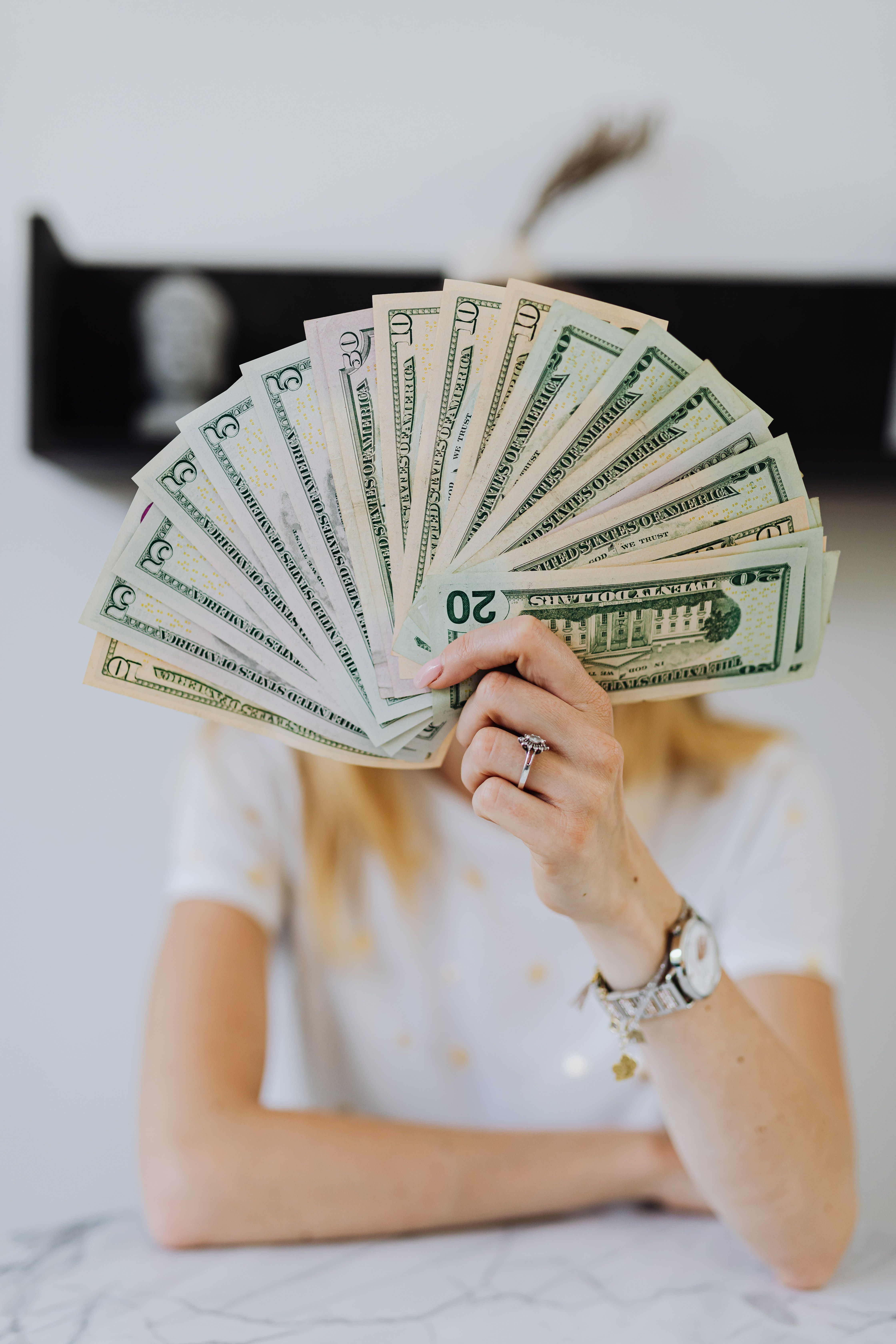 4480x6720 Woman Holding Fan of US Dollar Bills · Free