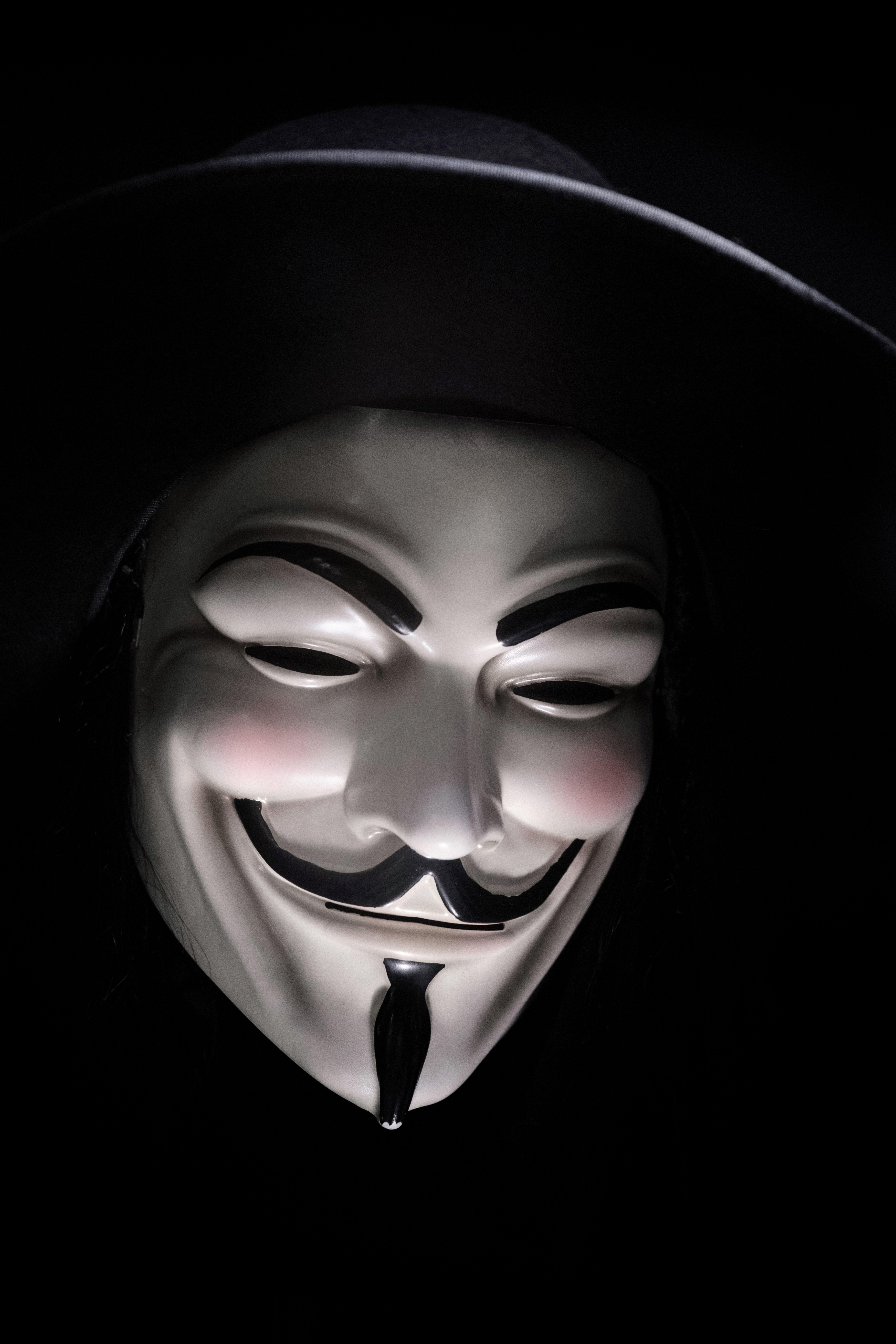 5461x8192 A smiling Guy Fawkes mask in shadow against a black background. Guy fawkes mask, Anonymous mask, Guy fawkes