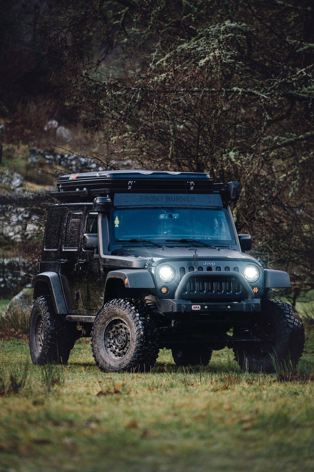 1000x1500 black Jeep Wrangler in forest at daytime photo