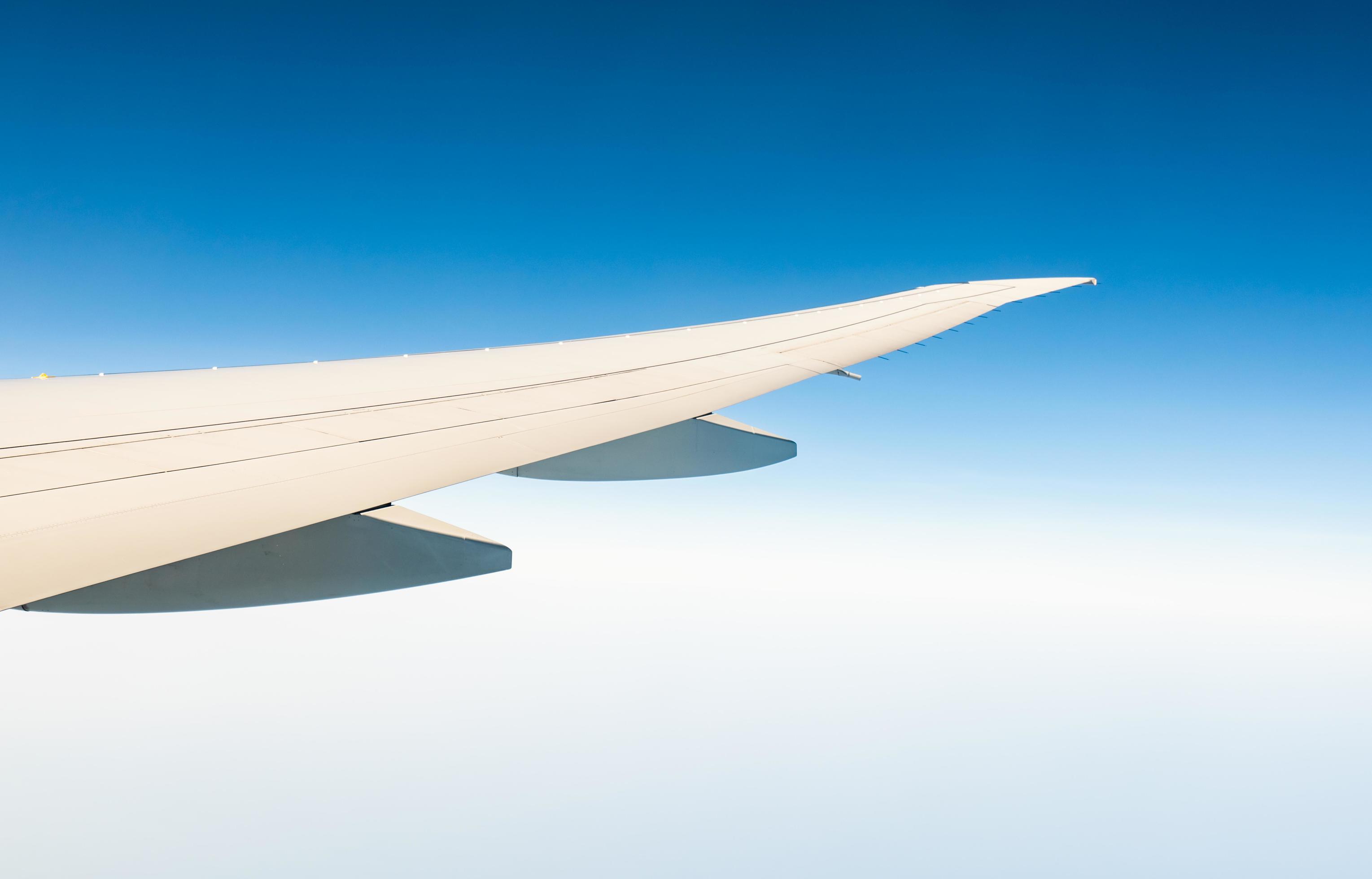 3058x1960 Wing of plane over white clouds. Airplane flying on clear blue sky. Scenic view from airplane window. Commercial airline flight. Plane wing above cloud. Flight mechanics concept. International flight. 7763917