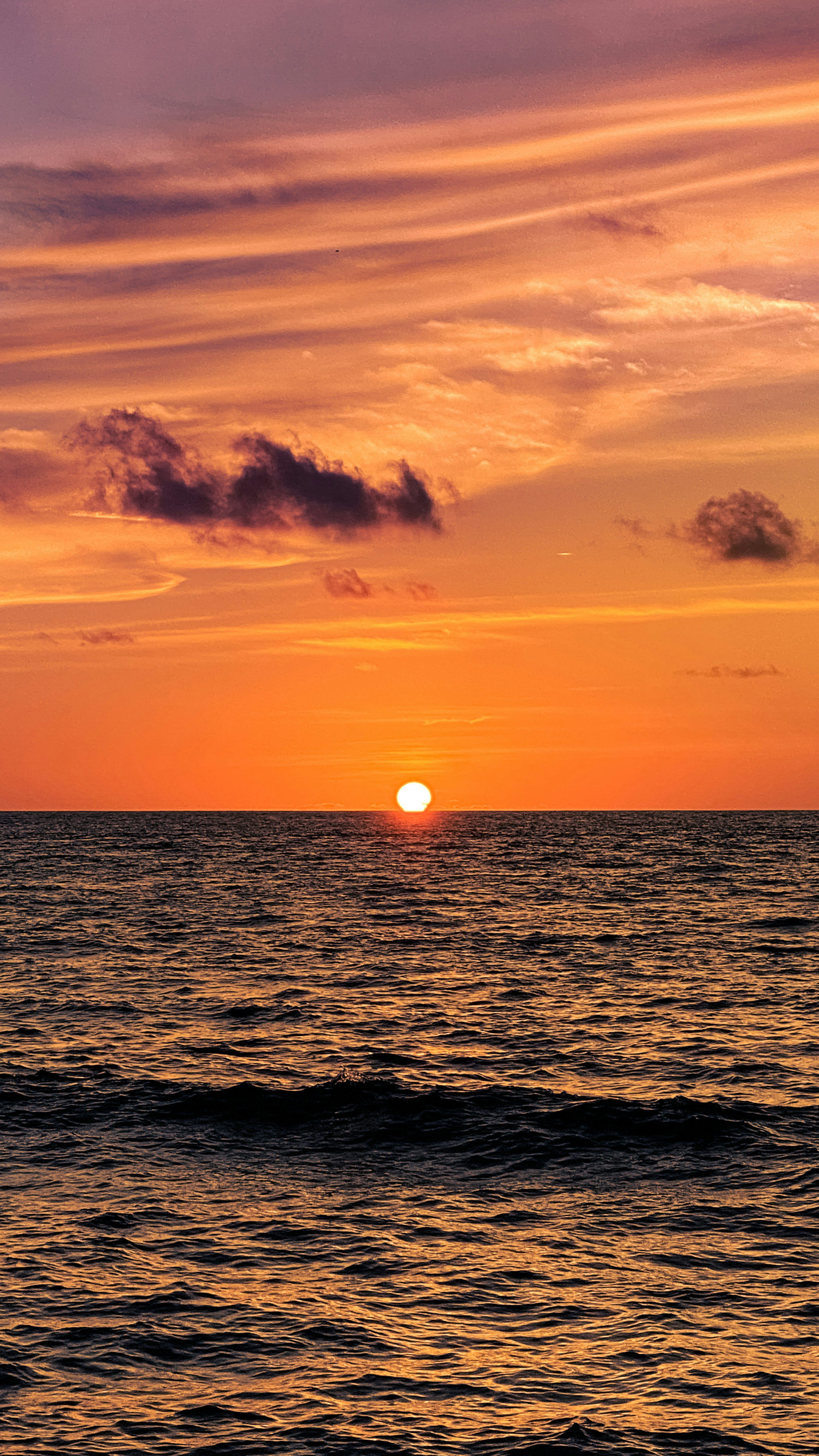 3000x5335 A sunset over the ocean with Sunset Beach in the background photo