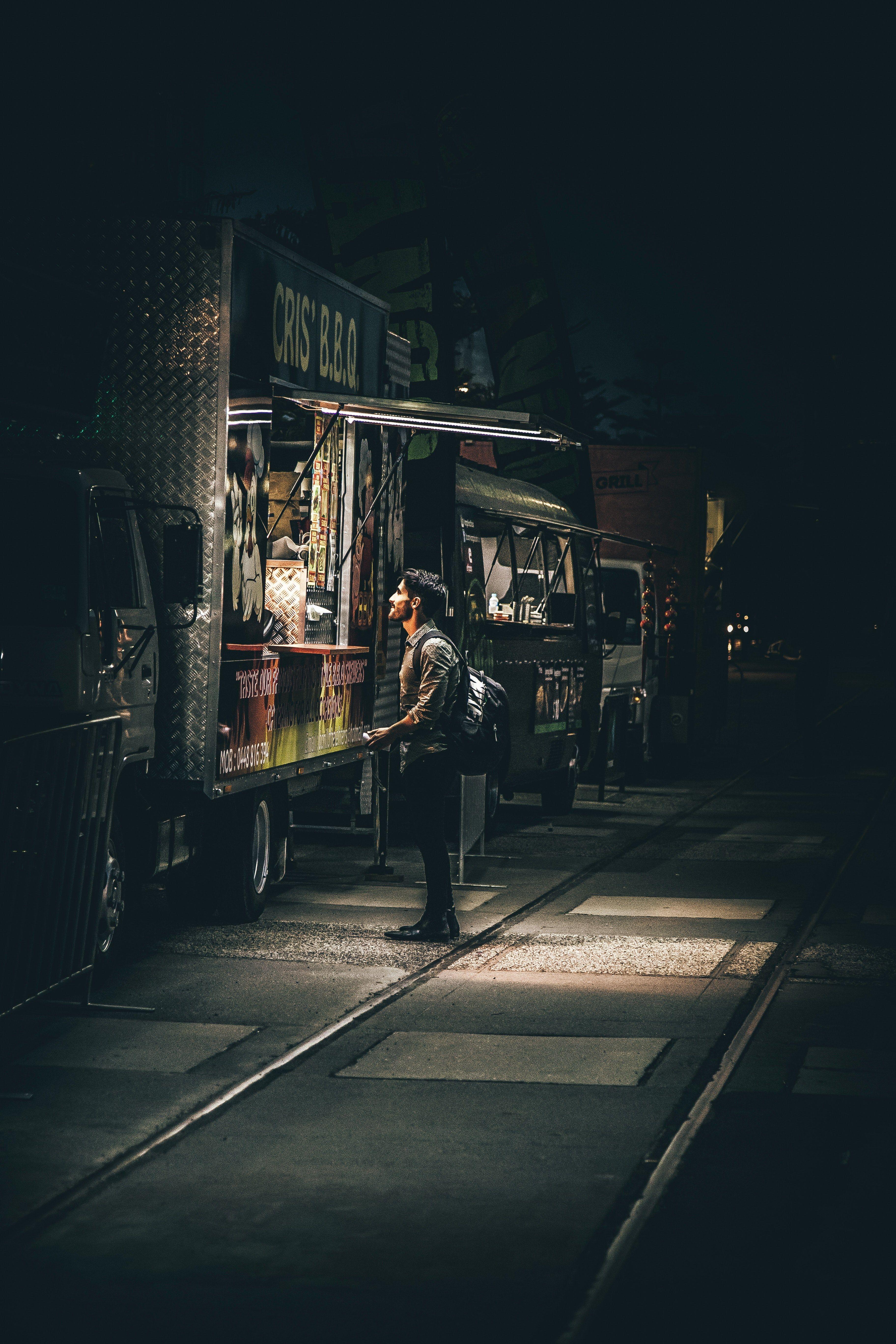 3648x5472 Wallpaper / a man waiting in front of a food truck at night, late night food truck 4k wallpaper