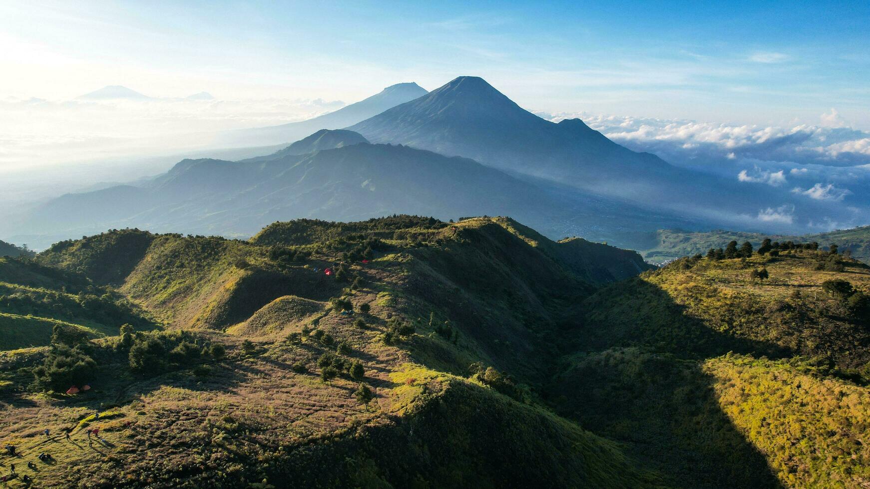 1742x980 Aerial view of beauty mountain peaks Prau Dieng, Central Java and the climbers and tent. Wonosobo, Indonesia
